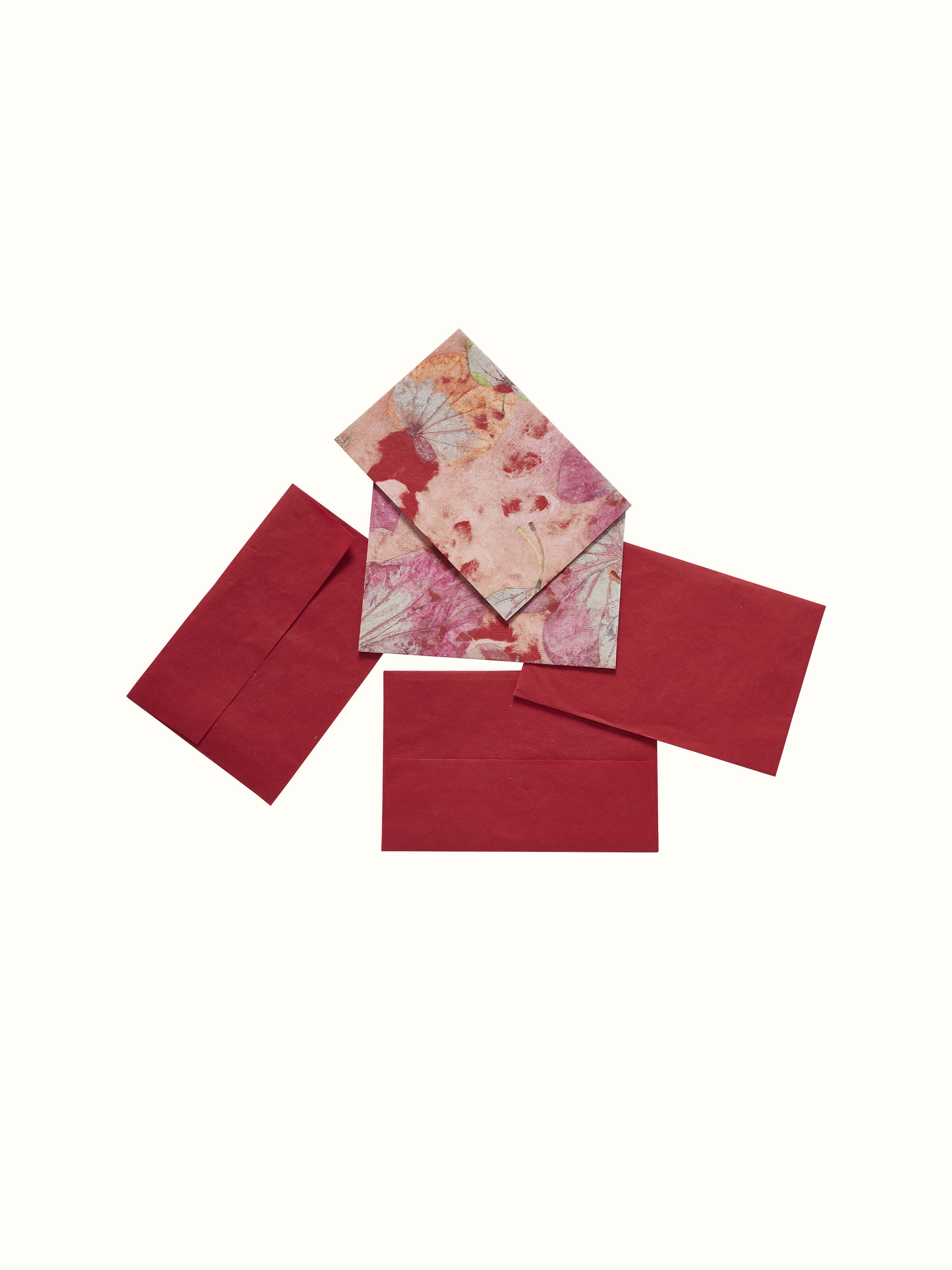Close-up of Auroville handmade paper money envelopes in red, showing the detailed texture and traditional craftsmanship