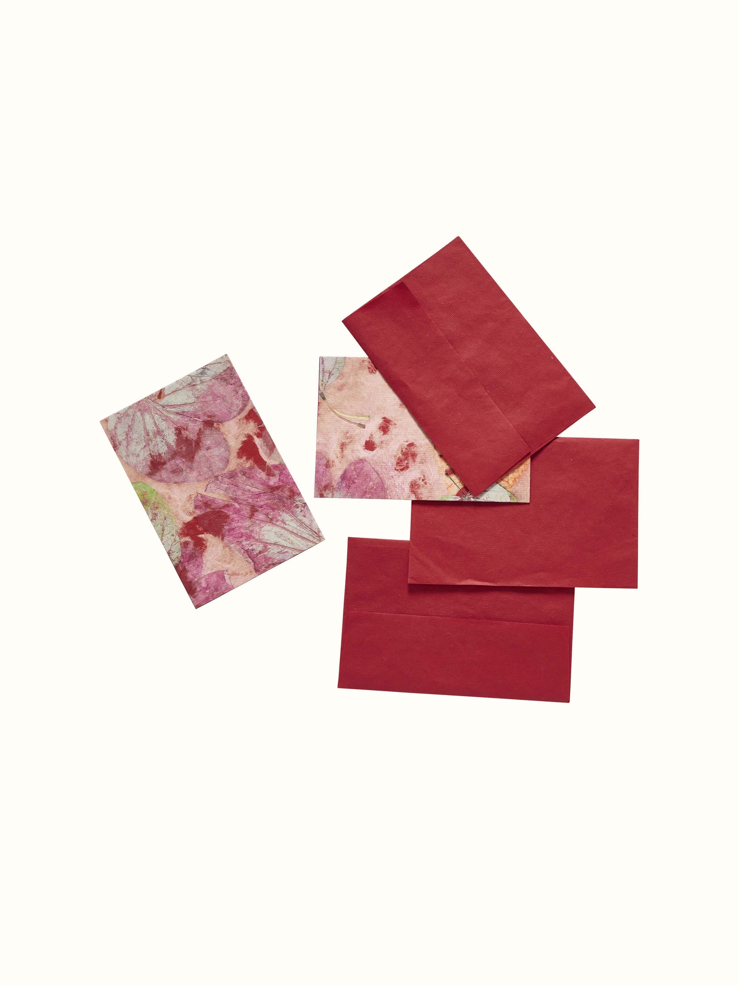 Angled view of Auroville handmade paper money envelopes in orange, set of 3, emphasizing the texture and artistic design.