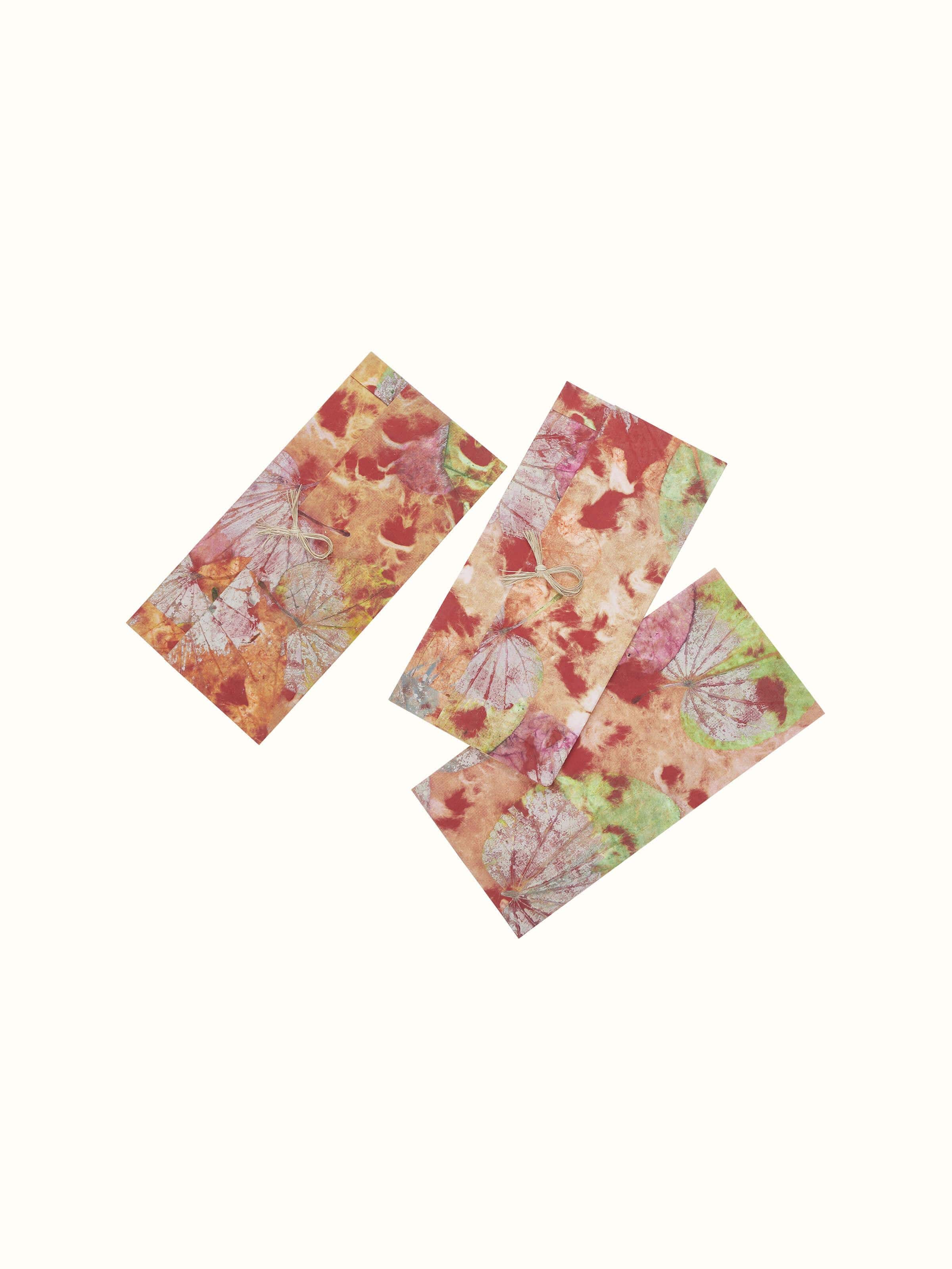 Close-up view of Auroville handmade paper money envelopes in orange, set of 3, highlighting the craftsmanship and color.