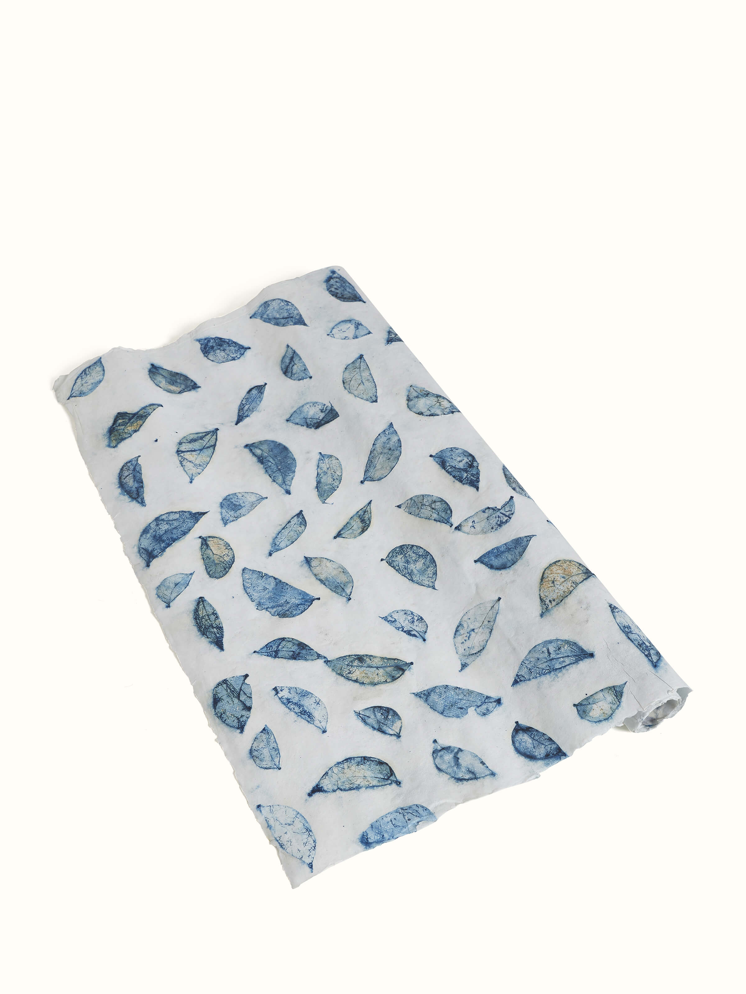 Detailed view of Auroville handmade paper wrapping sheets in blue, showcasing intricate paper texture and craftsmanship
