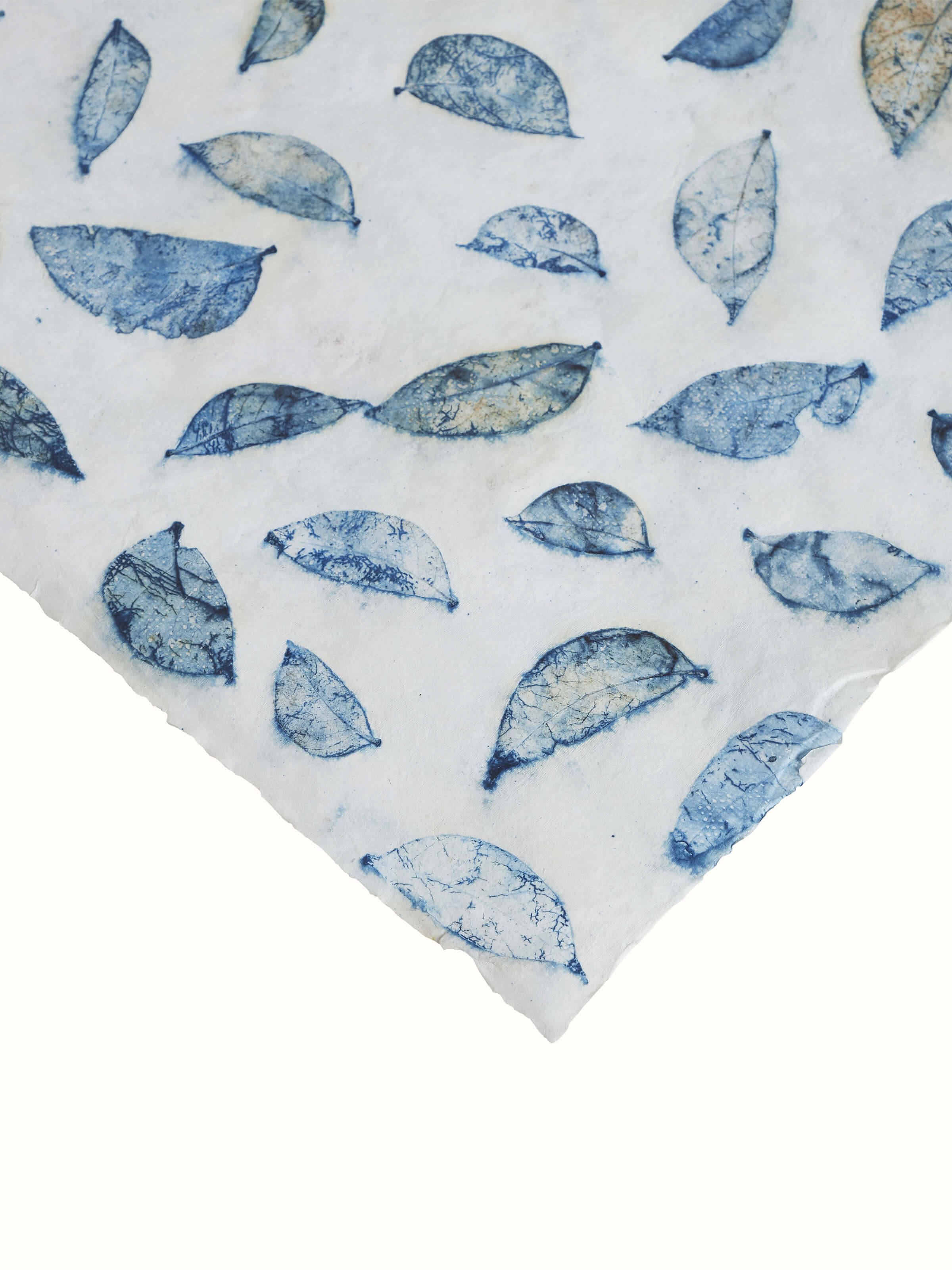Angled view of Auroville handmade paper wrapping sheets in blue, highlighting the smooth texture and rich color