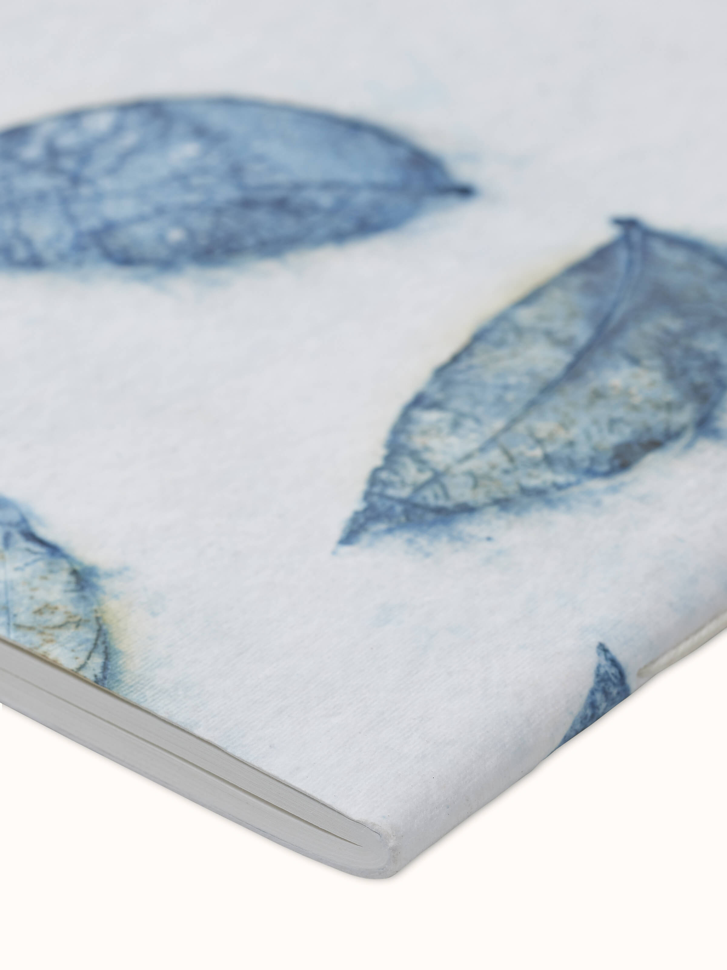 Close-up view of Auroville handmade paper notebook in blue, focusing on the detailed paper texture and color.