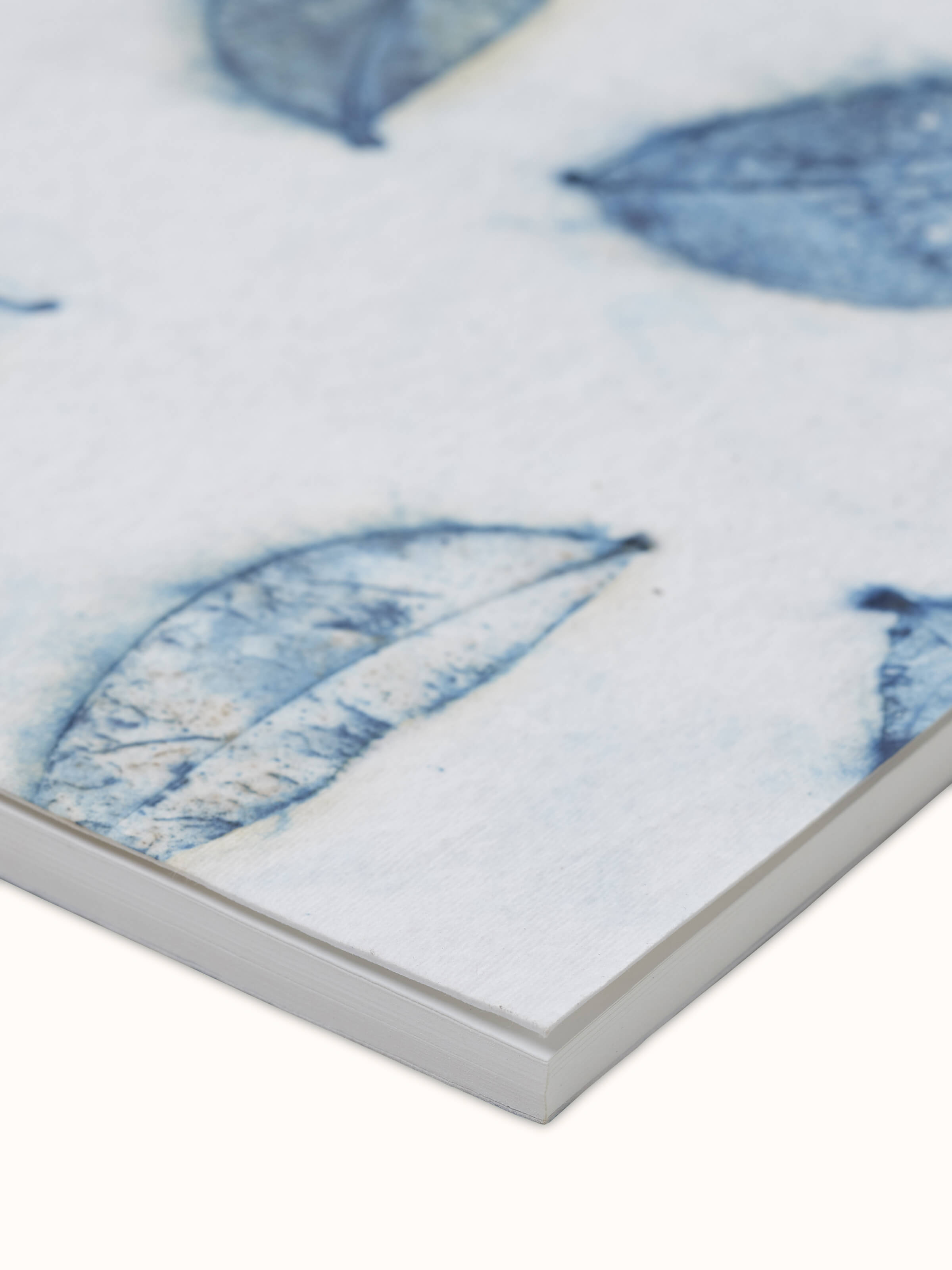 Detailed view of Auroville handmade paper notebook in blue, showcasing the artisanal quality and unique paper texture.