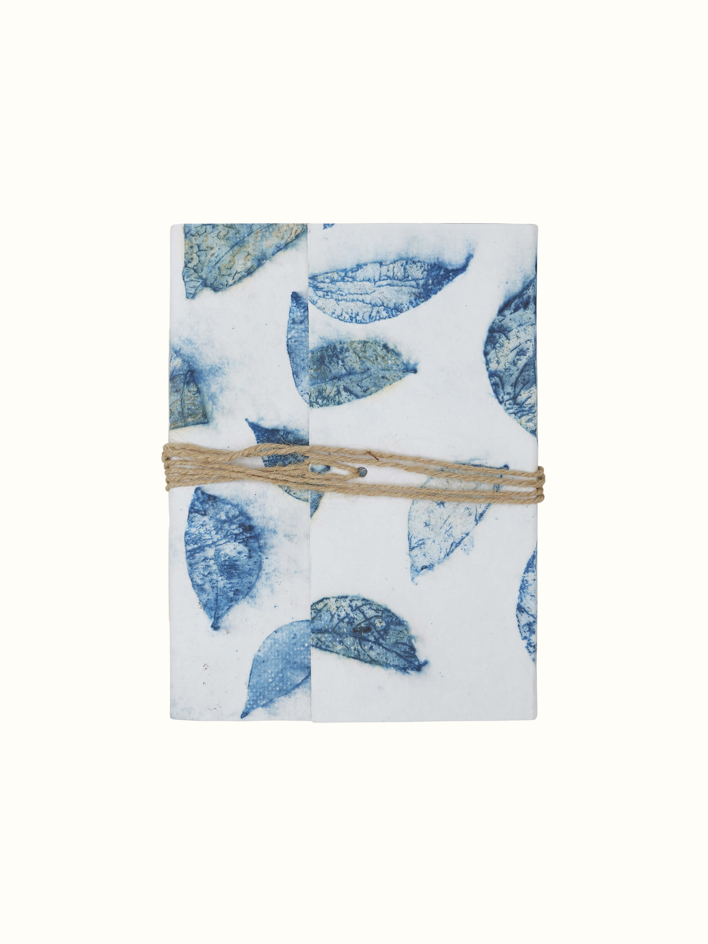 Angle view of Auroville handmade paper notebook with blue rope binding, highlighting the binding and paper quality