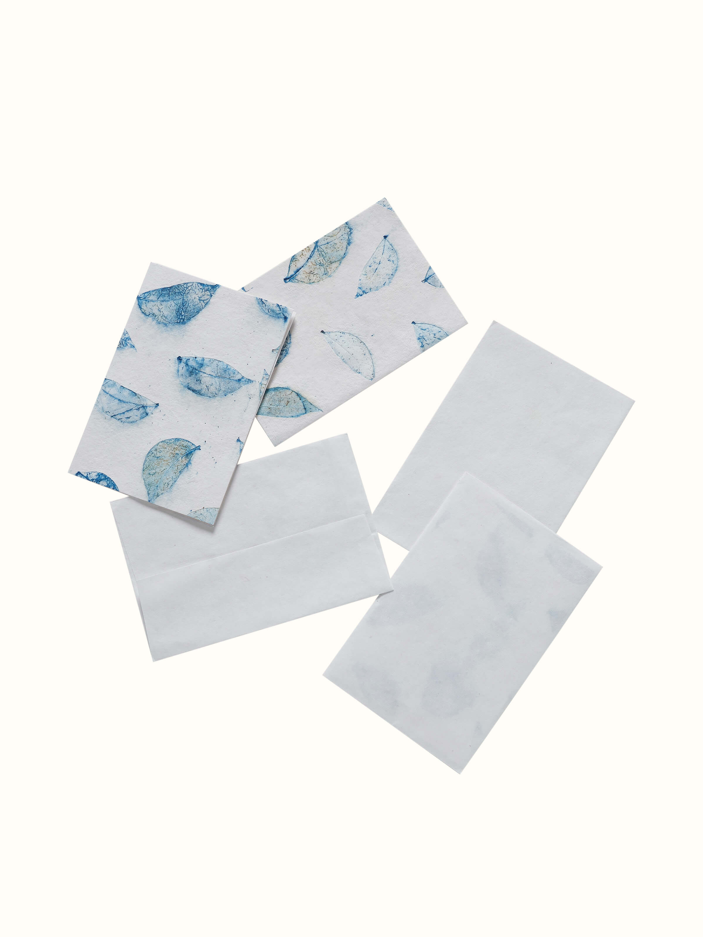 Close-up of Auroville handmade paper money envelopes in white, focusing on the fine details and texture.