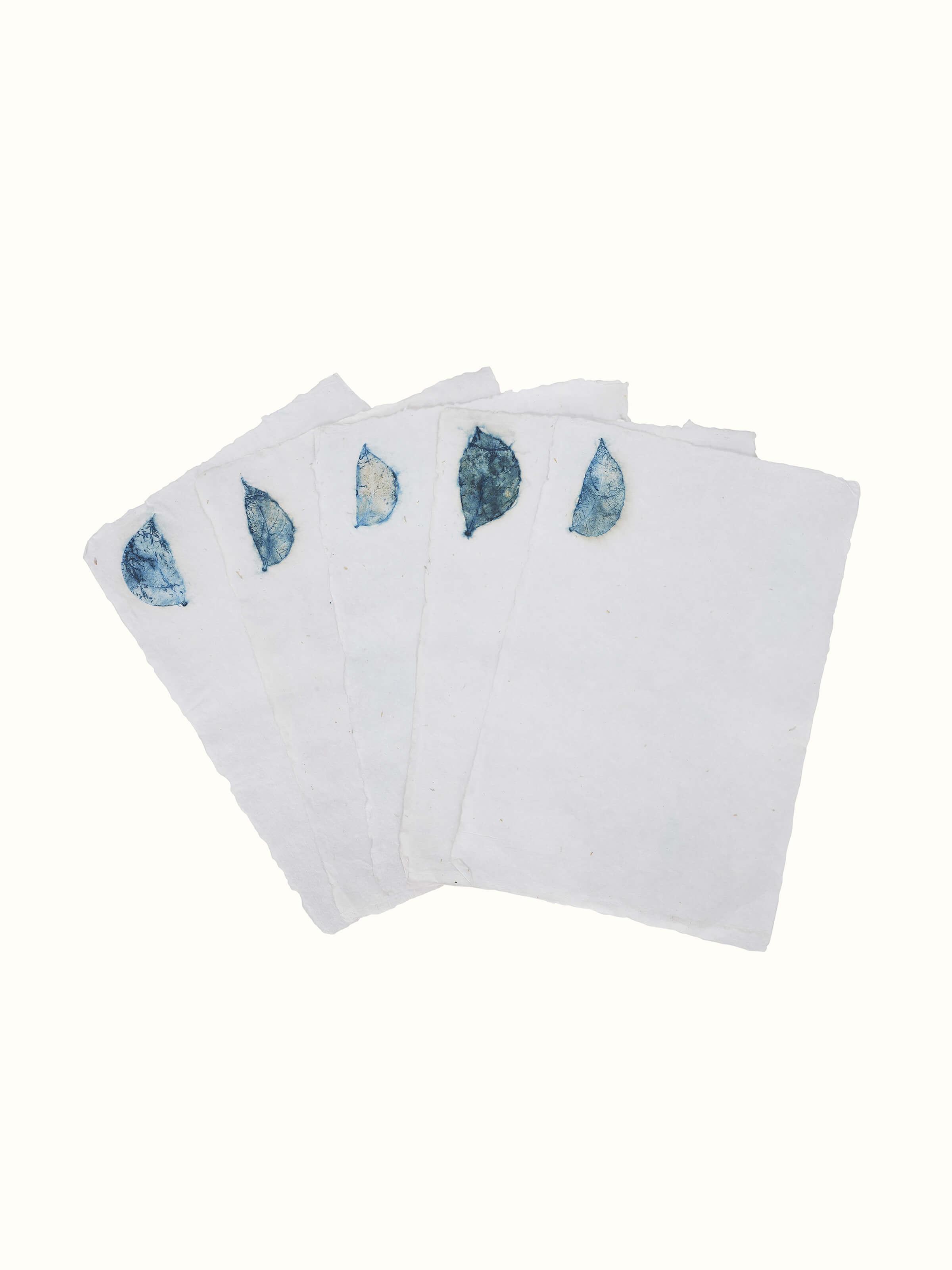 Close-up view of Auroville handmade paper sheets in white, showcasing their texture and quality.