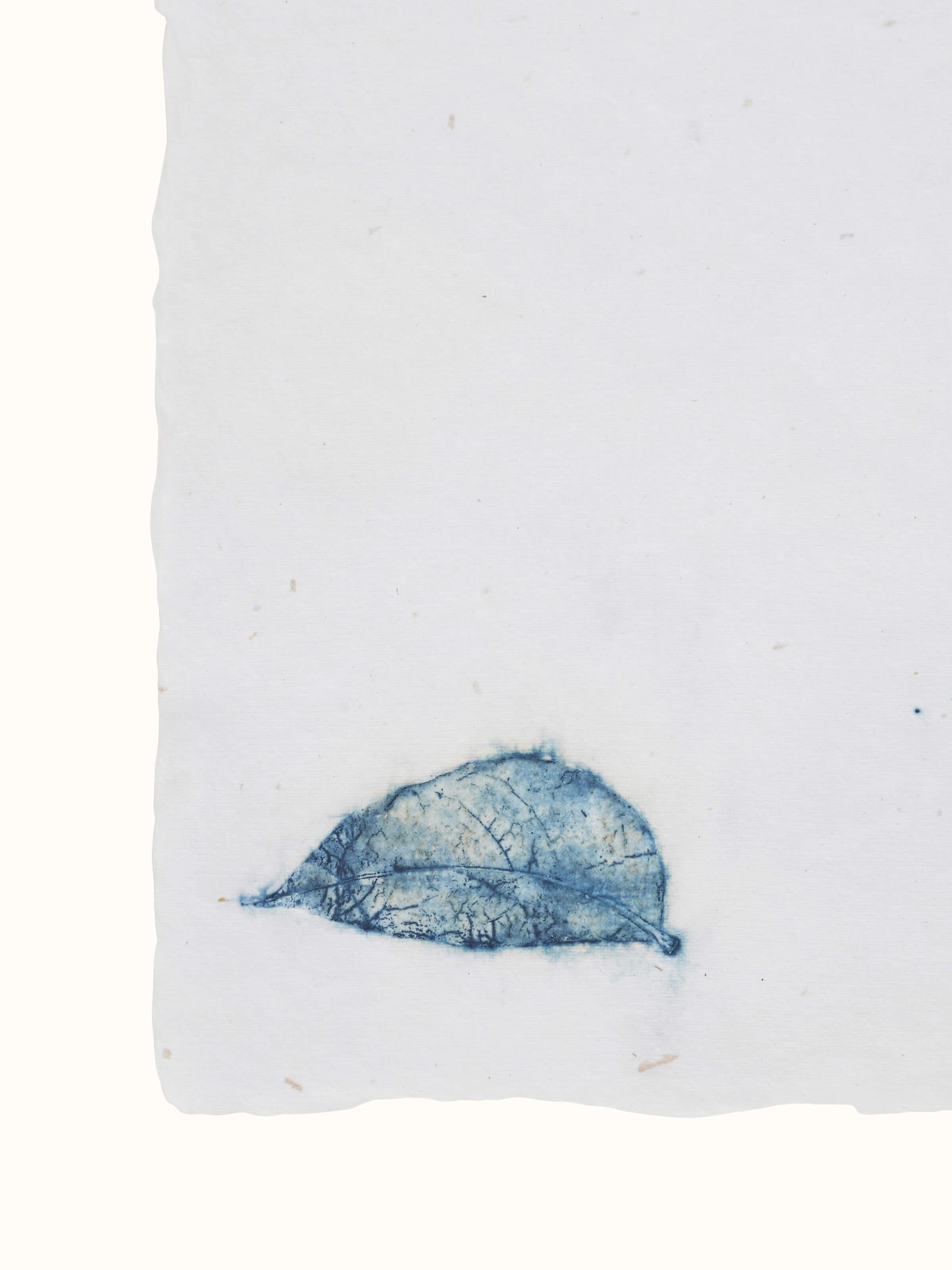 Angle view of Auroville handmade paper sheets in white, emphasizing their natural texture.