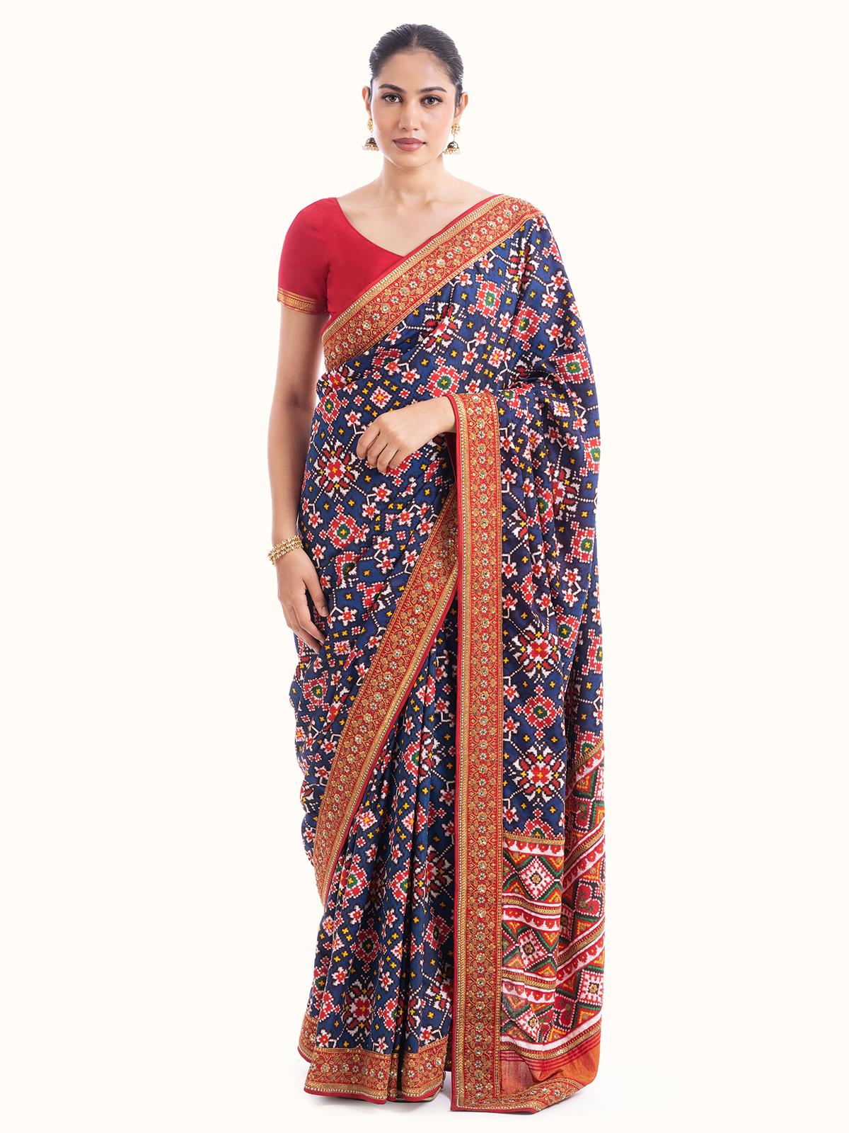 Navy blue Mulberry silk Patola saree with vibrant geometric and floral motifs, front view showcasing rich texture and traditional design.