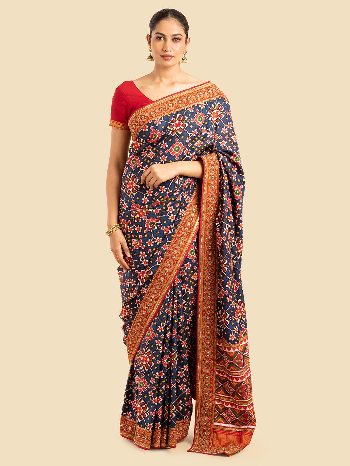 Model wearing navy blue Mulberry silk Patola saree, highlighting the intricate weaving and detailed border design.