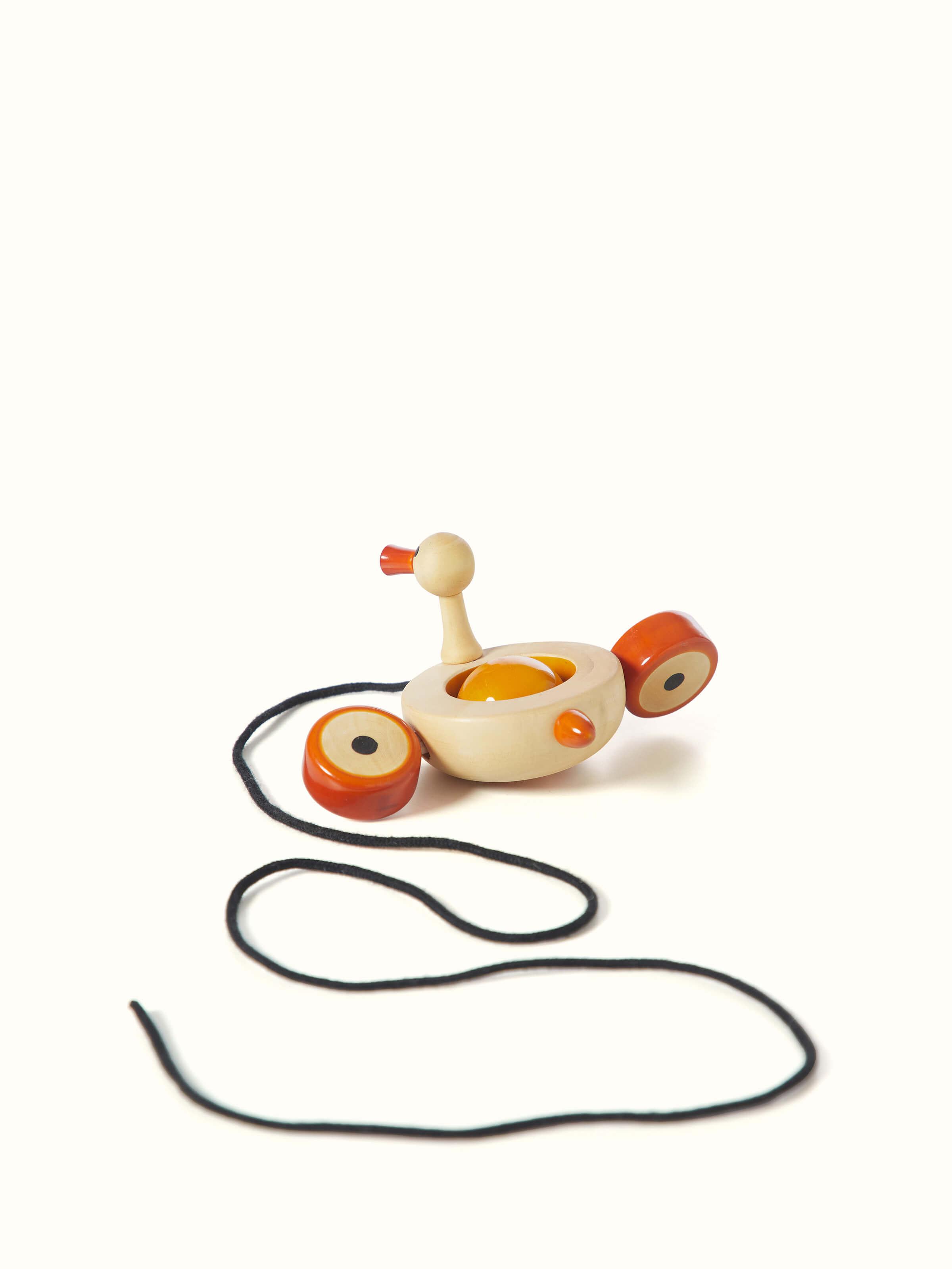 Detailed close-up of Channapatna Ivory Wood Duby Duck Toy, focusing on the wood texture and hand-carved details