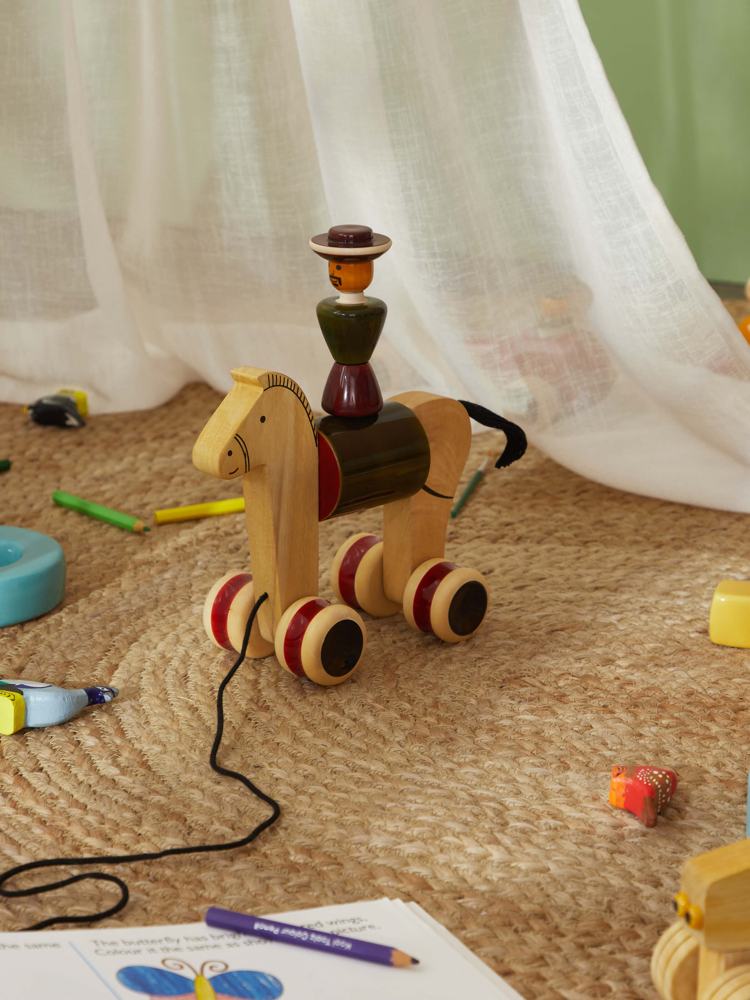 Close-up detail of Channapatna Ivory Wood Man Rider Toy Green highlighting the craftsmanship and wooden details.
