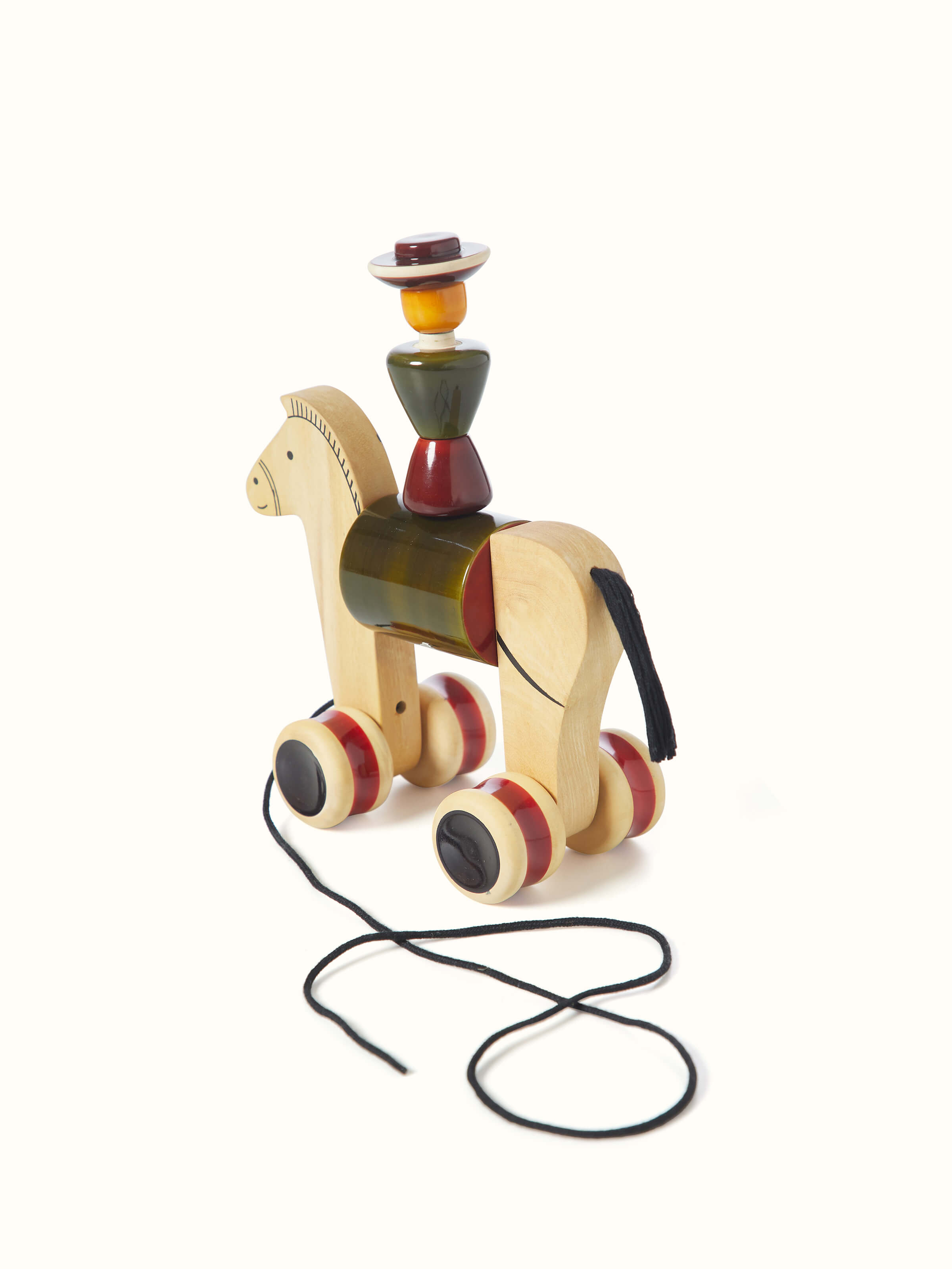 Side view of Channapatna Ivory Wood Man Rider Toy Green showcasing the profile and wooden texture.