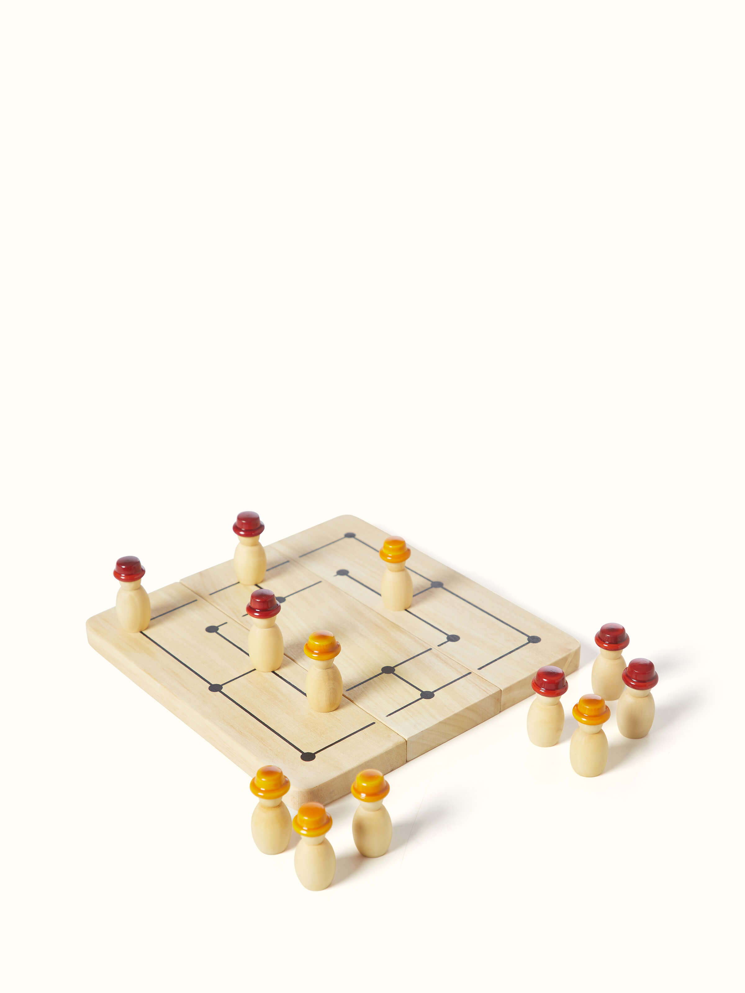 Side view of Channapatna ivory wood six men's morris off-white