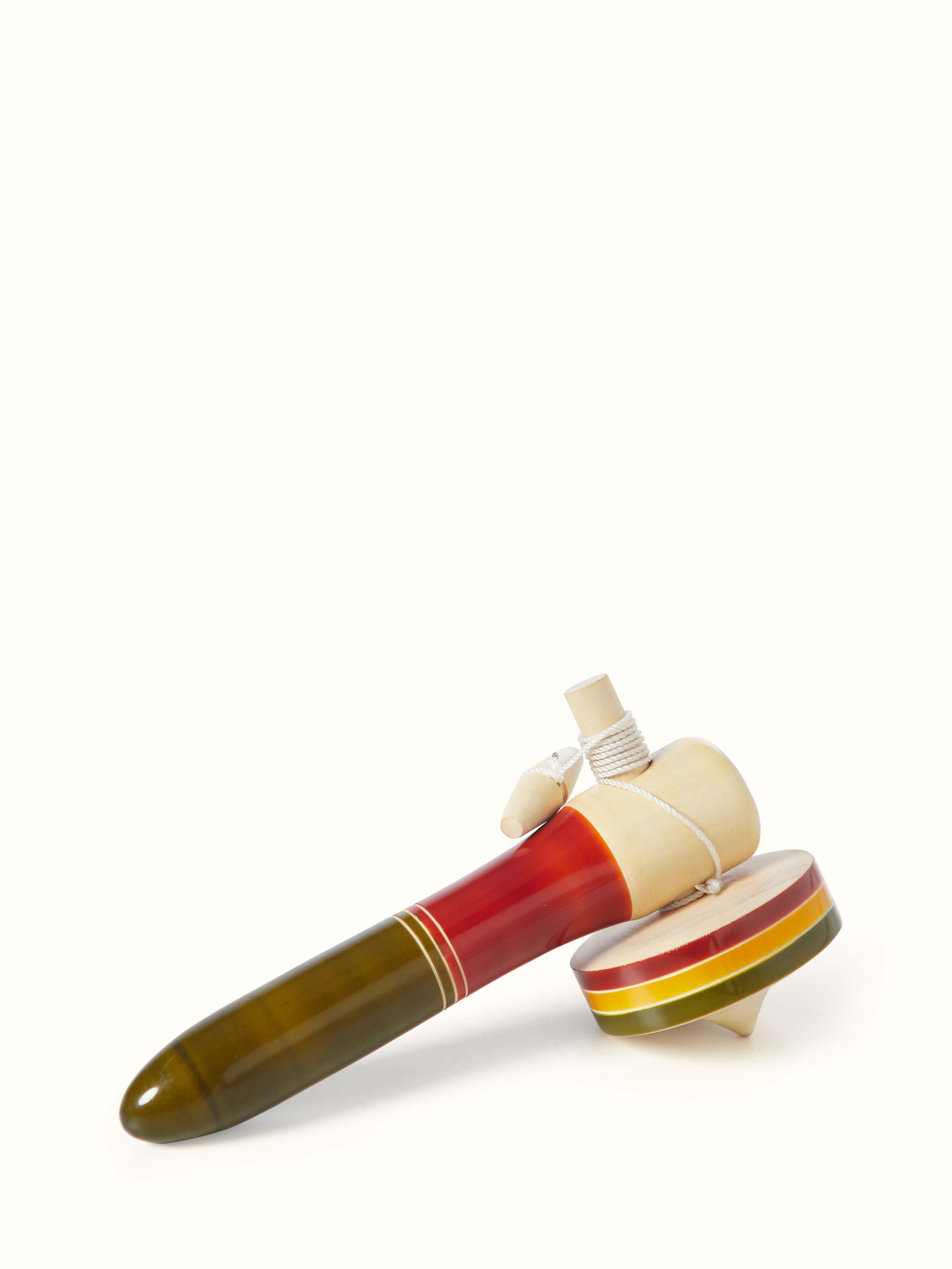 Detailed view of Channapatna ivory wood merry top emphasizing its craftsmanship.