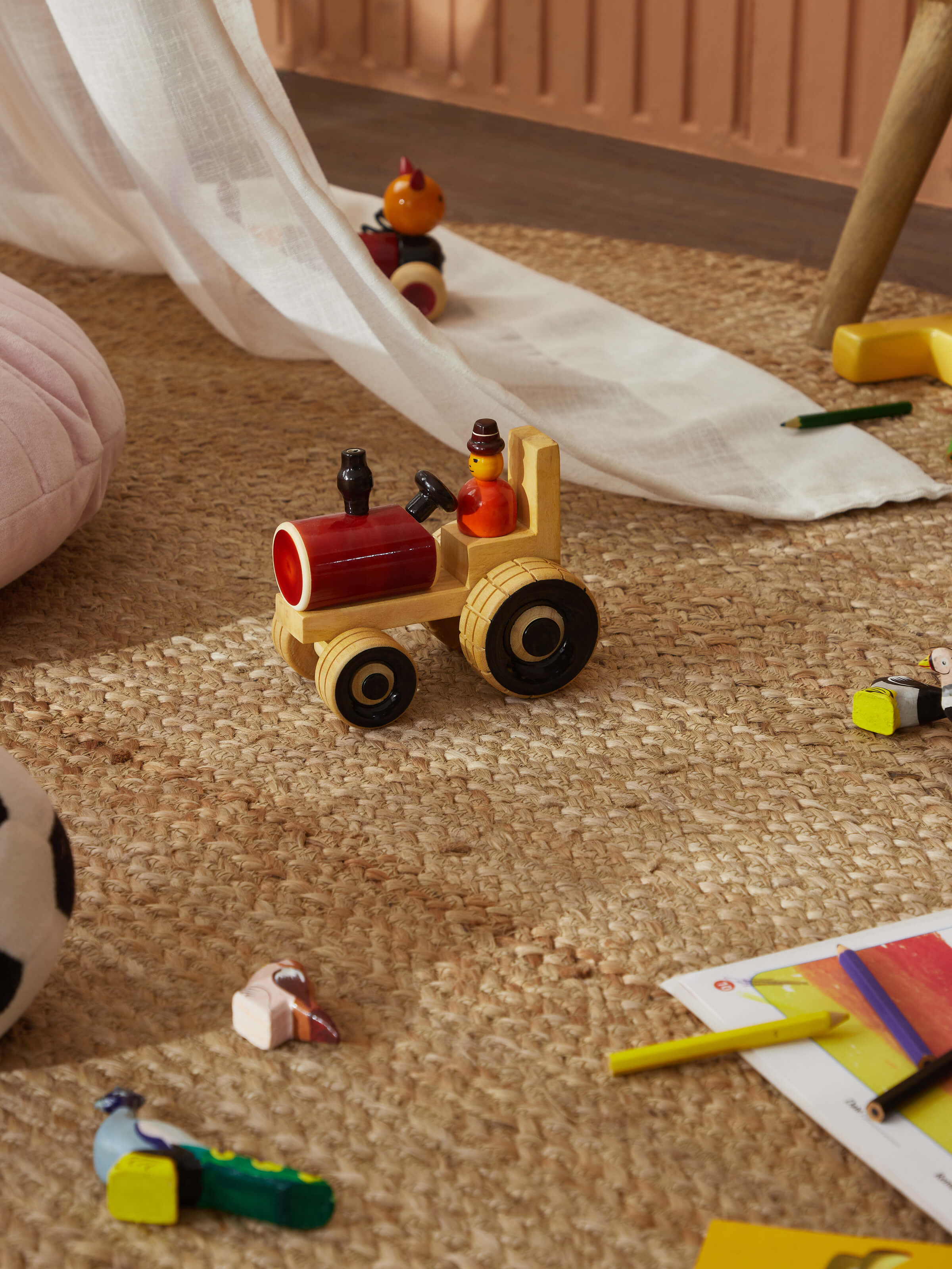 Side view of Channapatna ivory wood tractor toy in red color highlighting its smooth finish and classic design