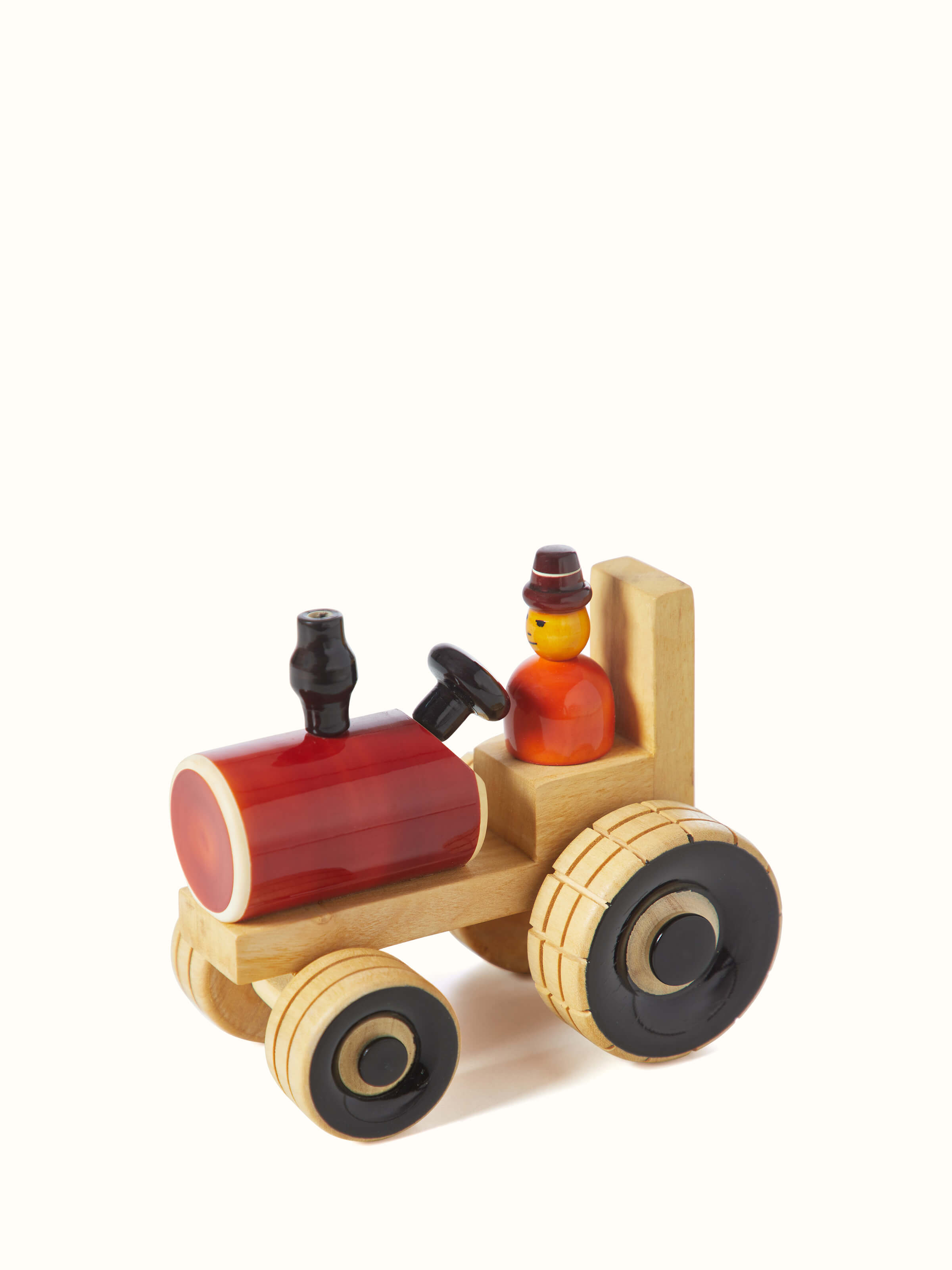Angled view of Channapatna ivory wood tractor toy in red color emphasizing the toy's detailed wooden construction