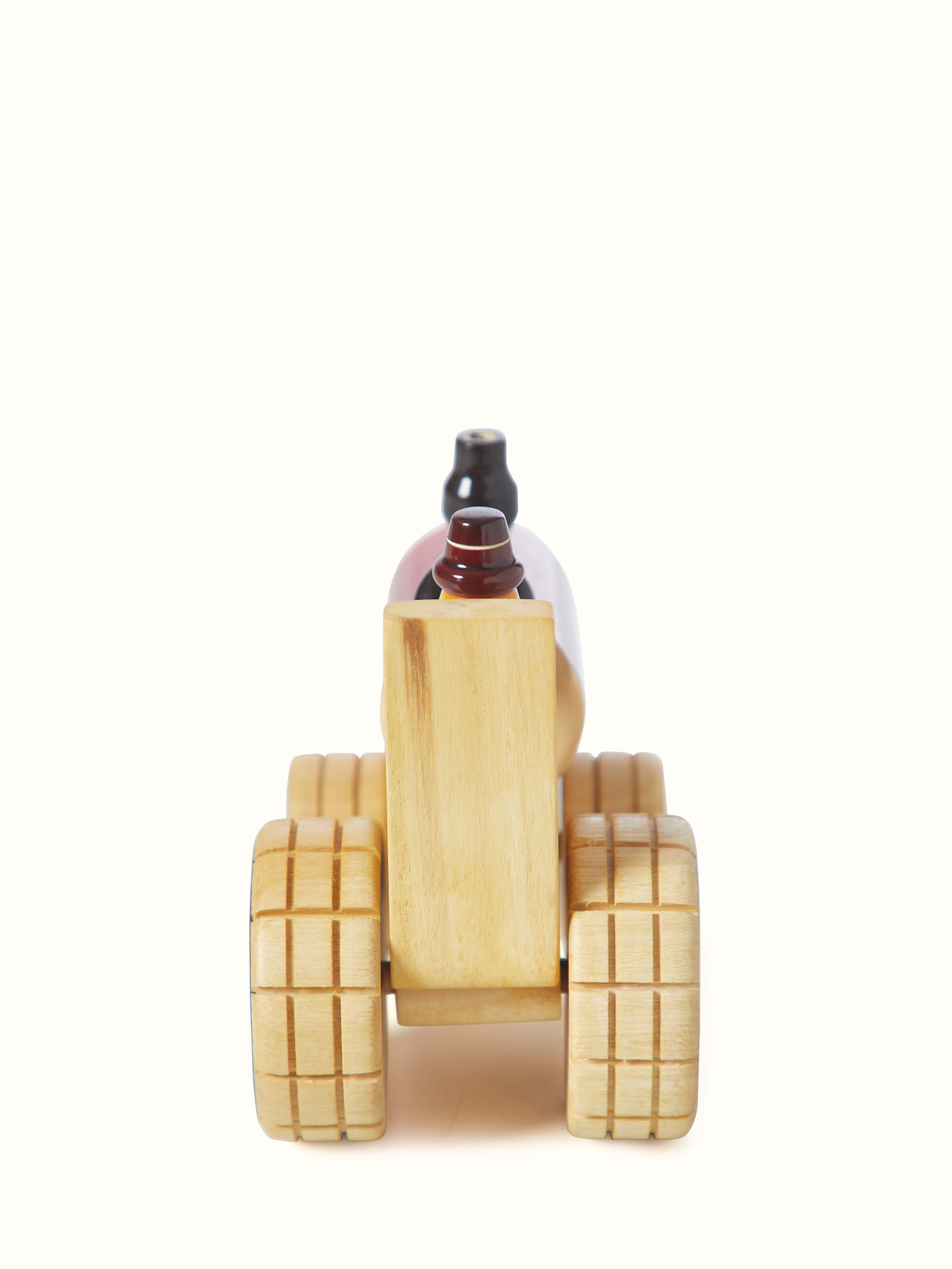 Close-up view of Channapatna ivory wood tractor toy in red color focusing on the fine wooden details and finish