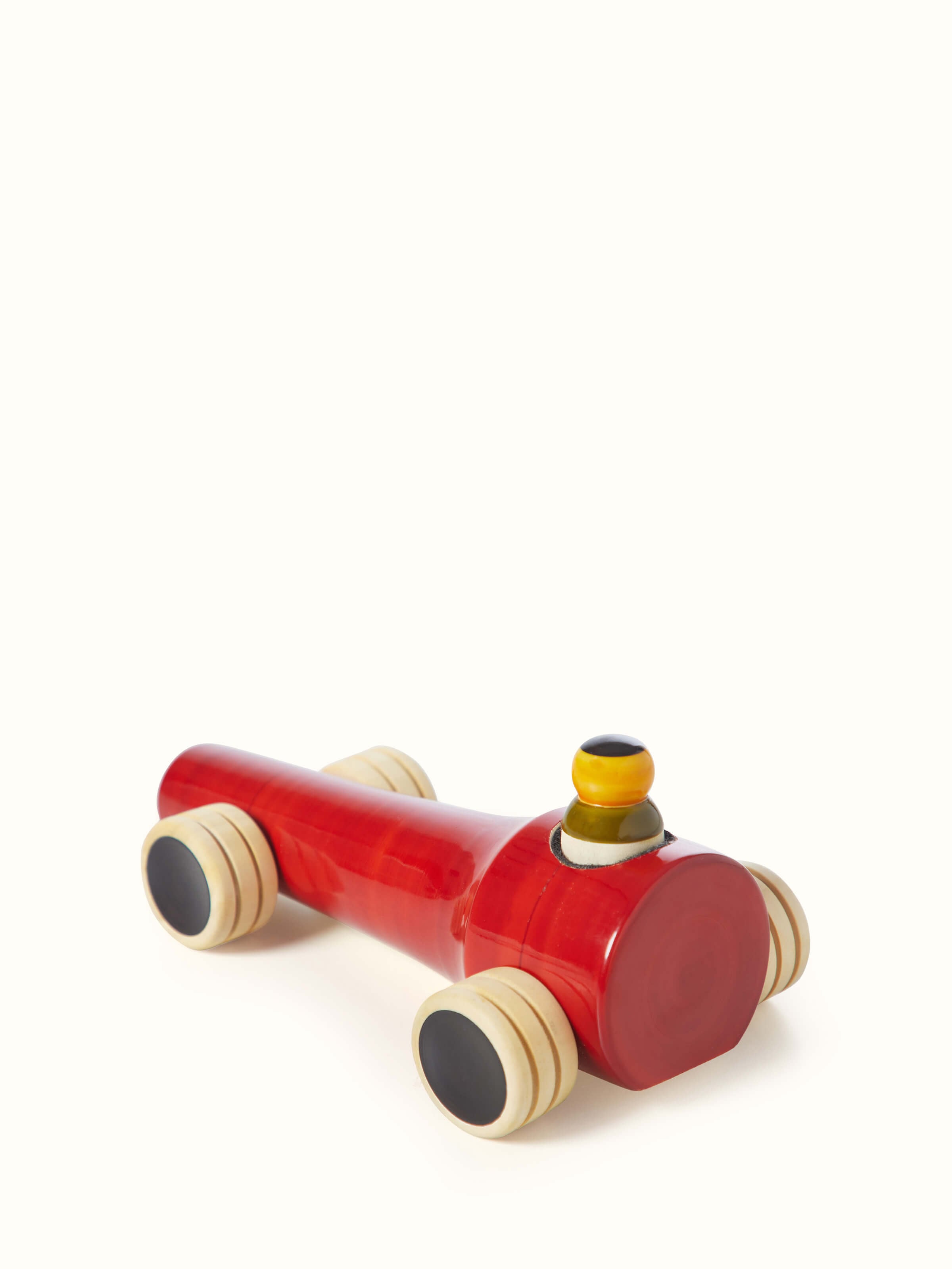 Top view of Channapatna ivory wood vroom toy in red, highlighting the toy's design and craftsmanship.