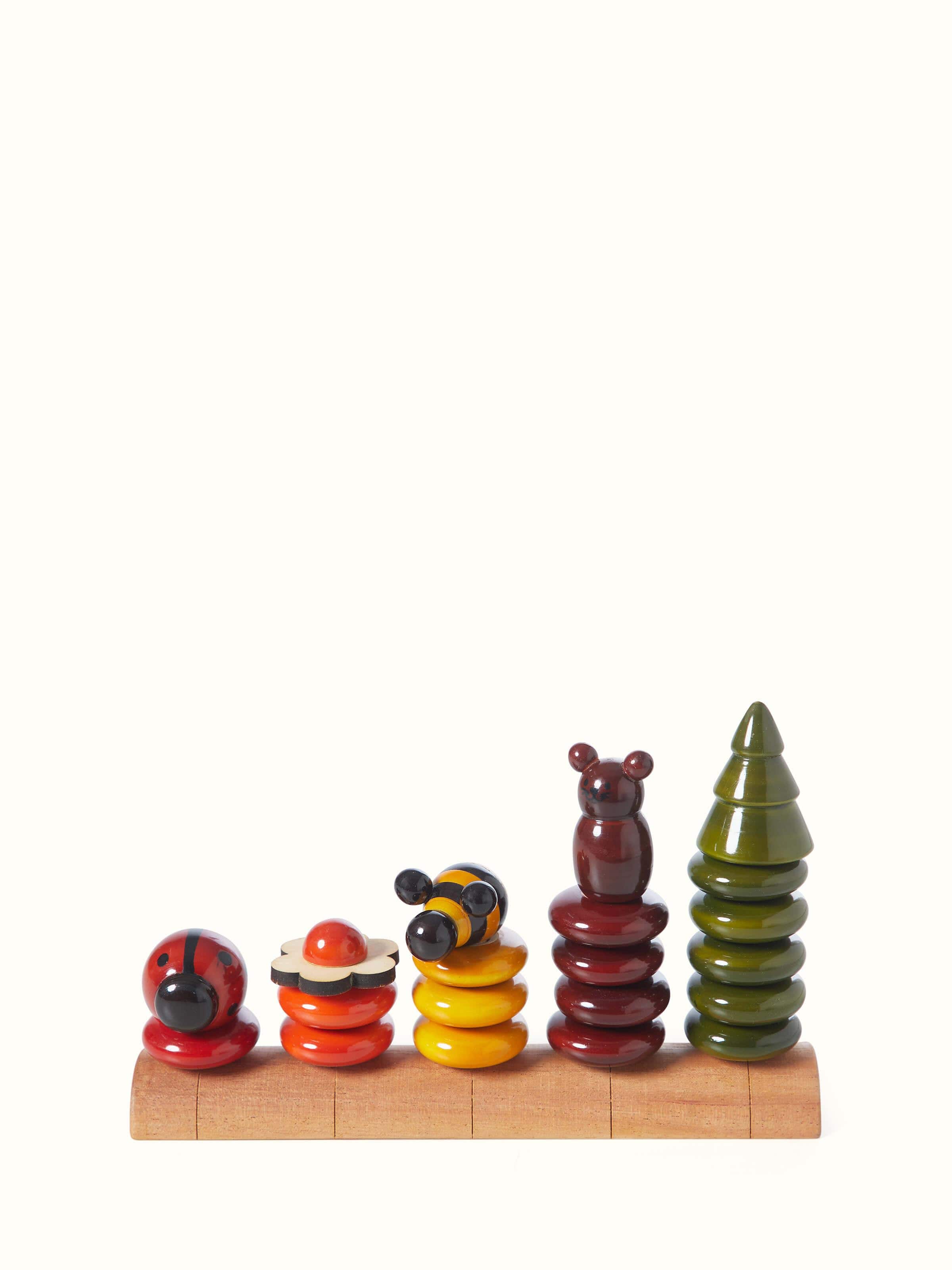 Front view of Channapatna ivory wood peppy five educational toy set, showcasing colorful and engaging designs.