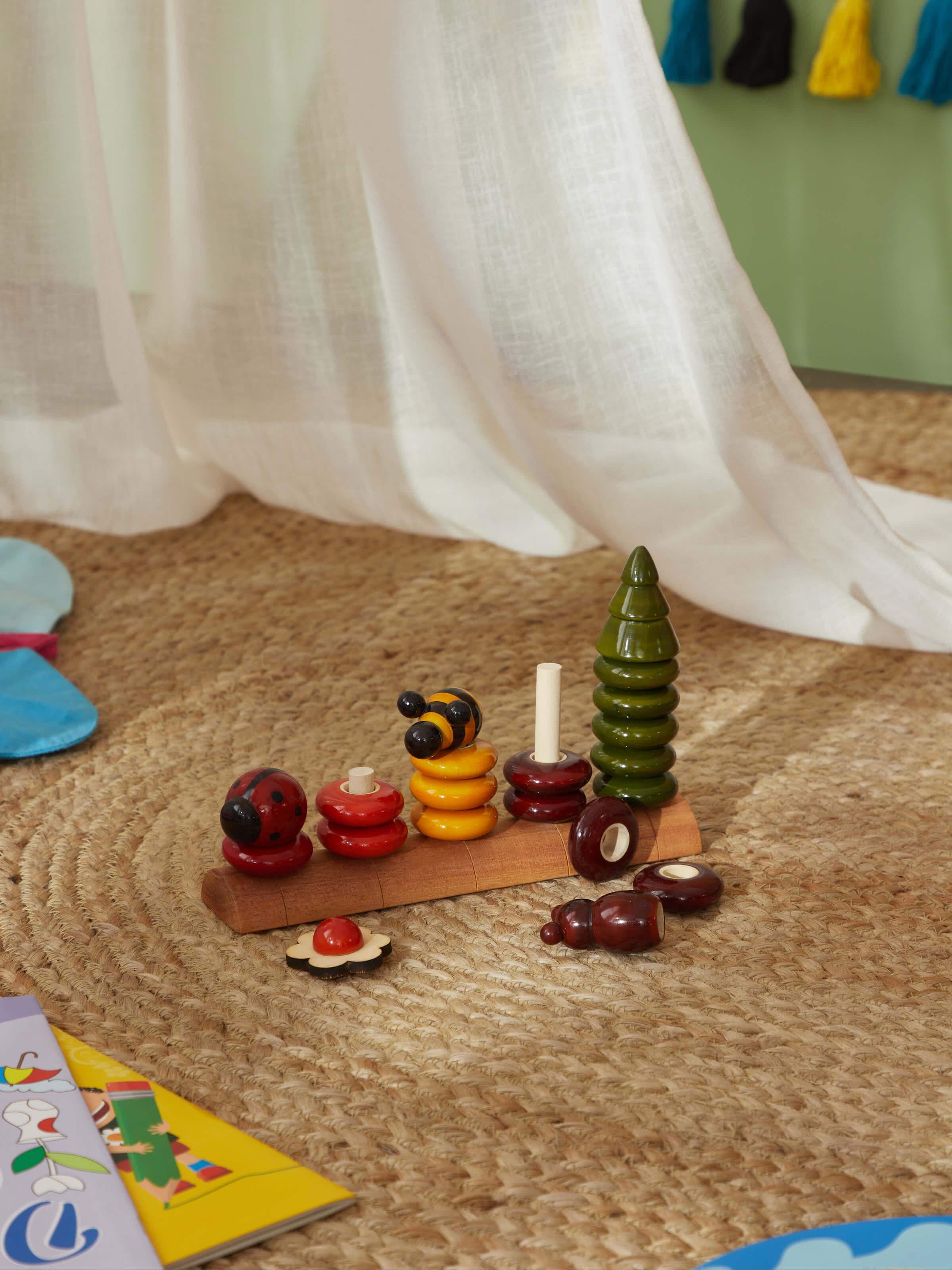 Side view of Channapatna ivory wood peppy five educational toy set, highlighting its educational features.