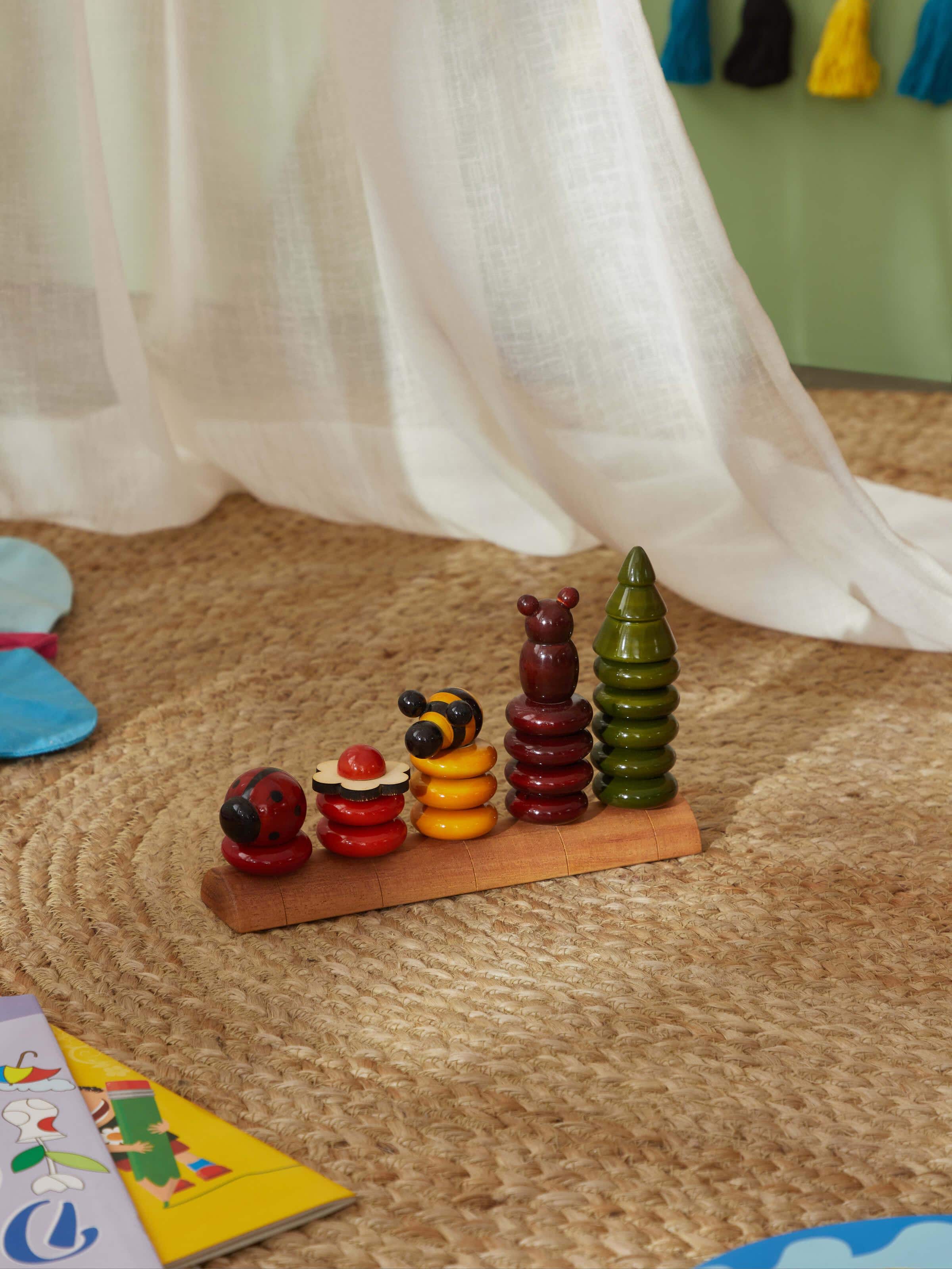 Close-up view of Channapatna ivory wood peppy five educational toy set, focusing on detailed craftsmanship.