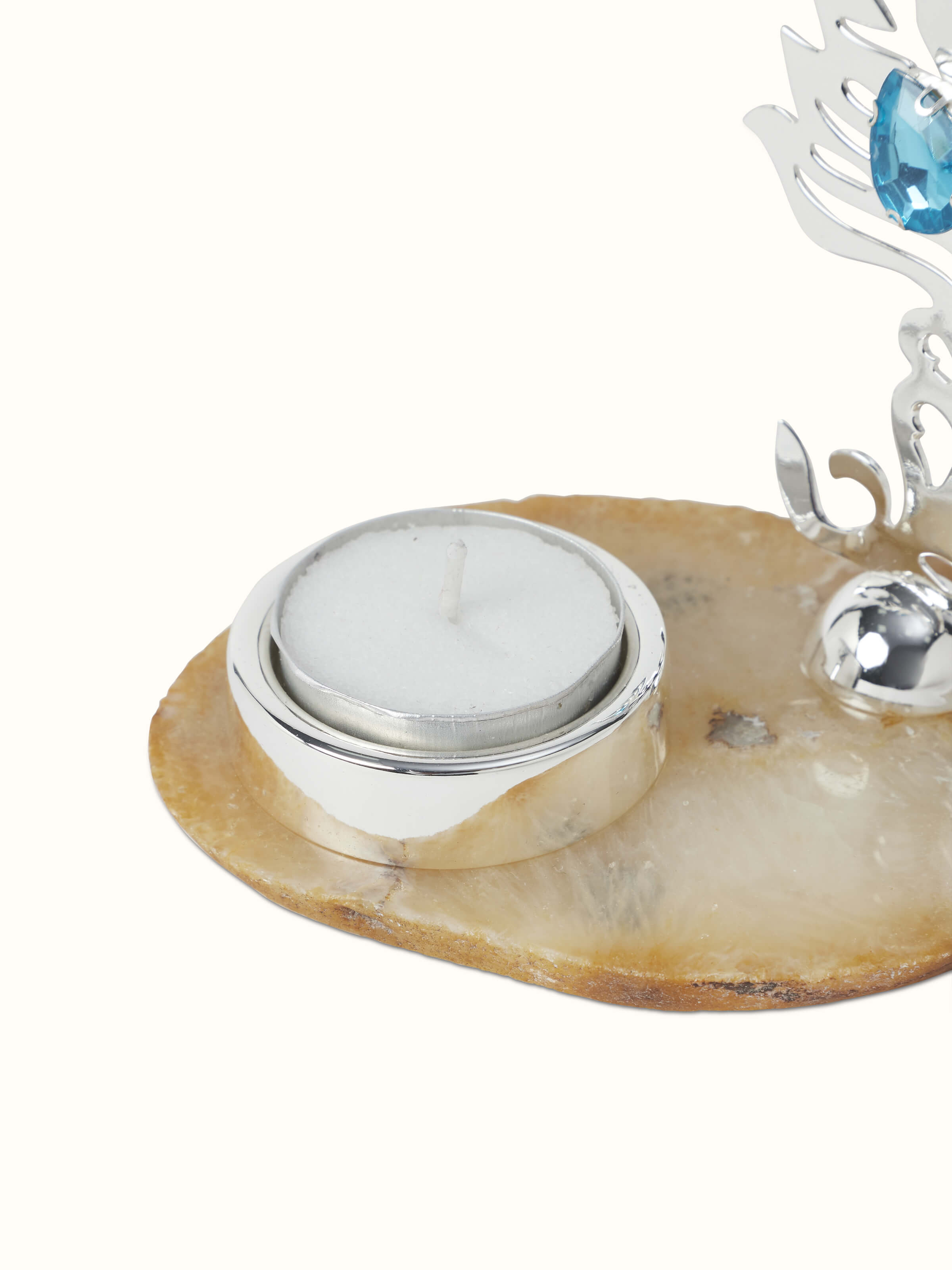 Angled view of the silver-plated feather tea light holder, highlighting the elegant design and reflective finish.