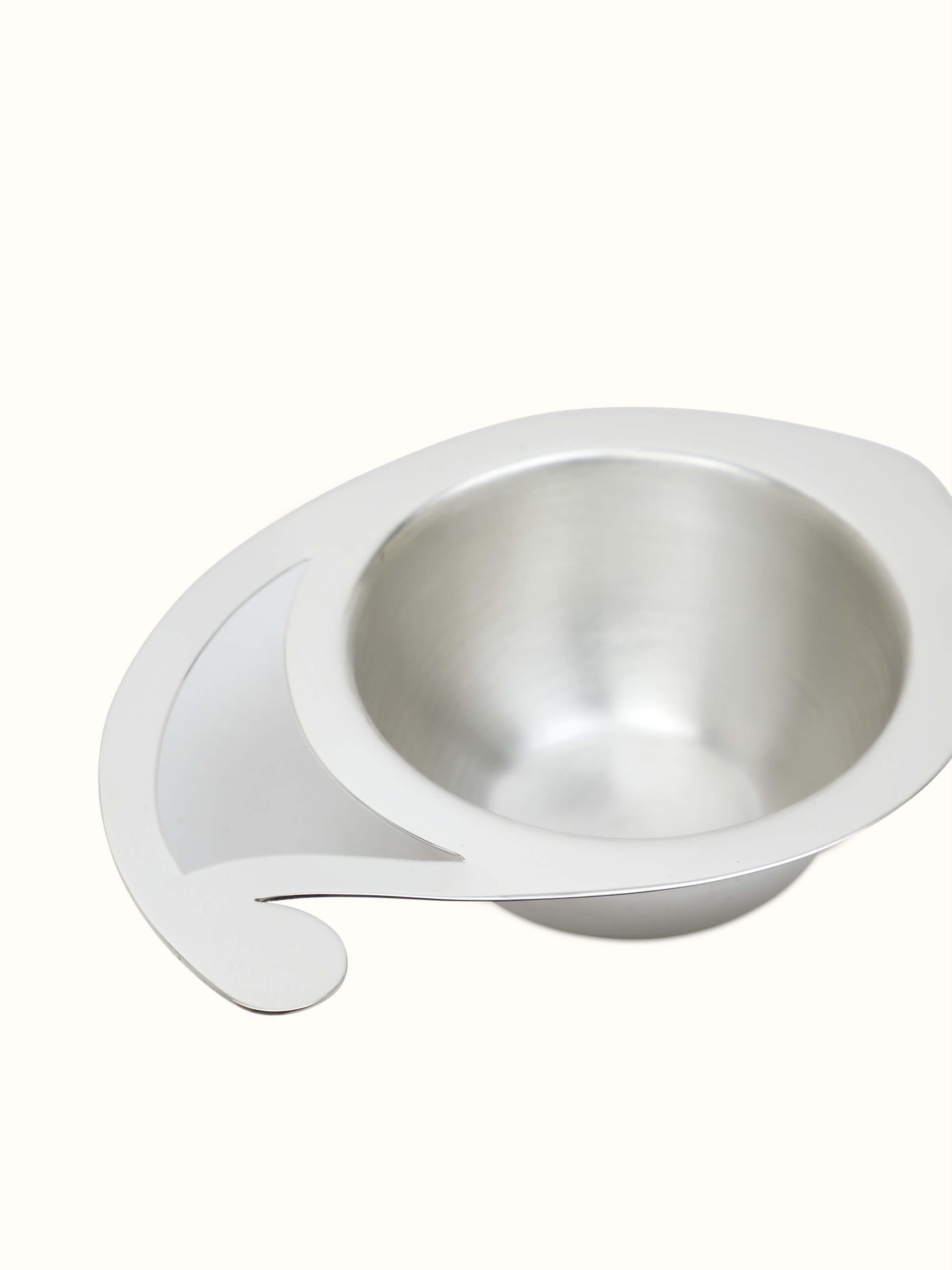 Angled view of Silver paisley diya, emphasizing its intricate design and gleaming surface.