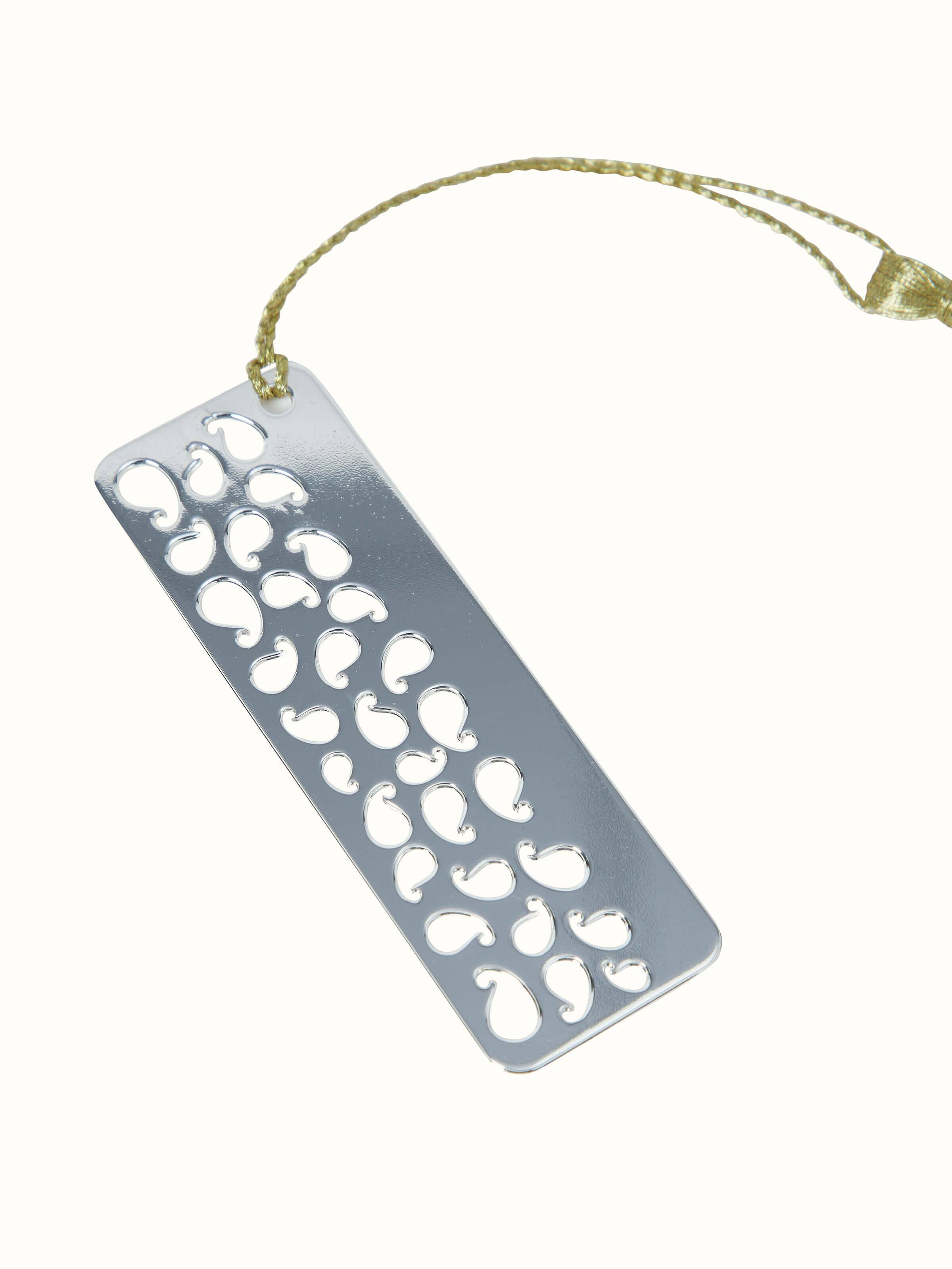 Close-up of silver-plated paisley bookmark with detailed craftsmanship.