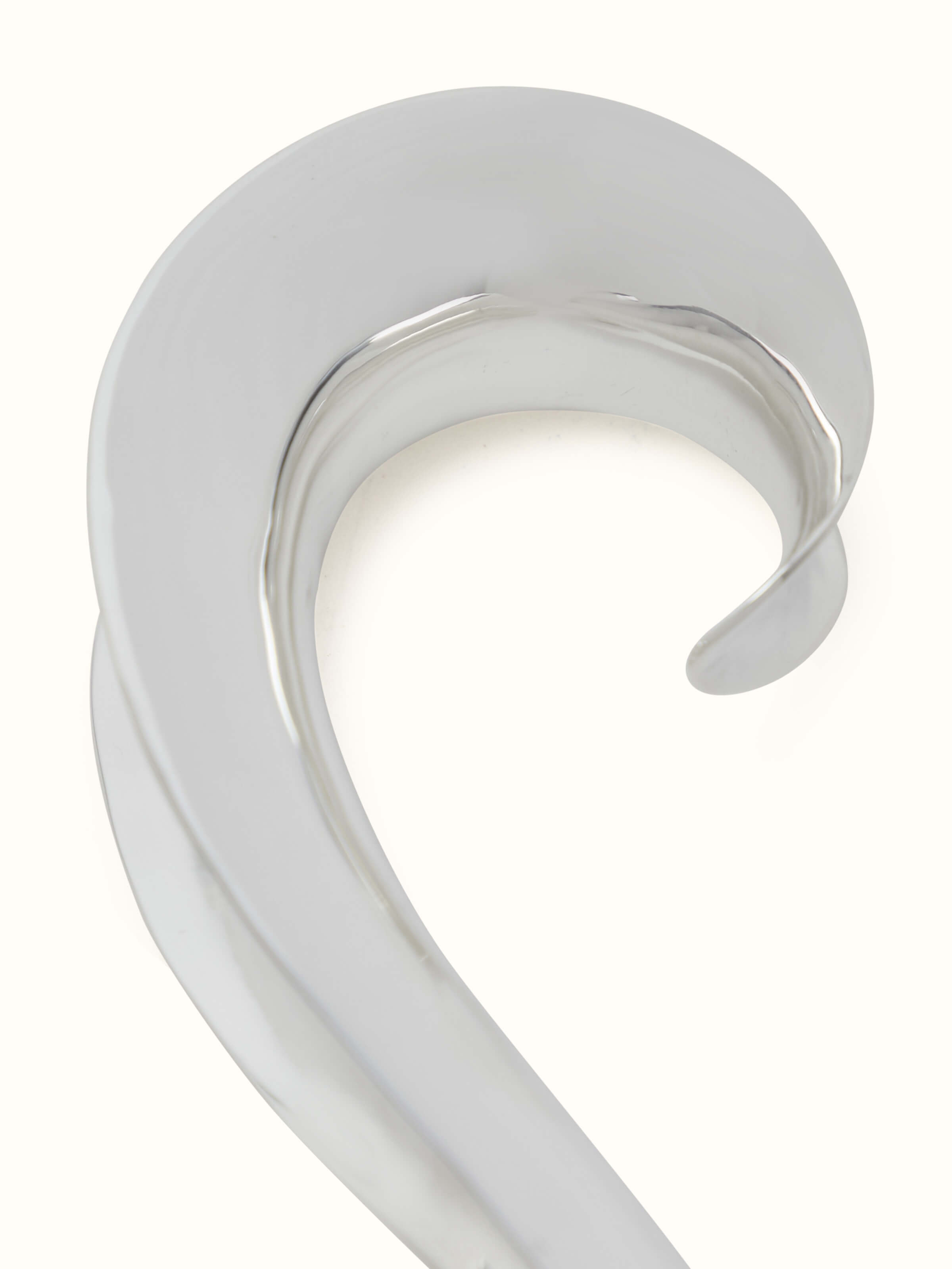 Alternate angle of Silver Curved Handle Rattle Toy showing its curved design and reflective quality.