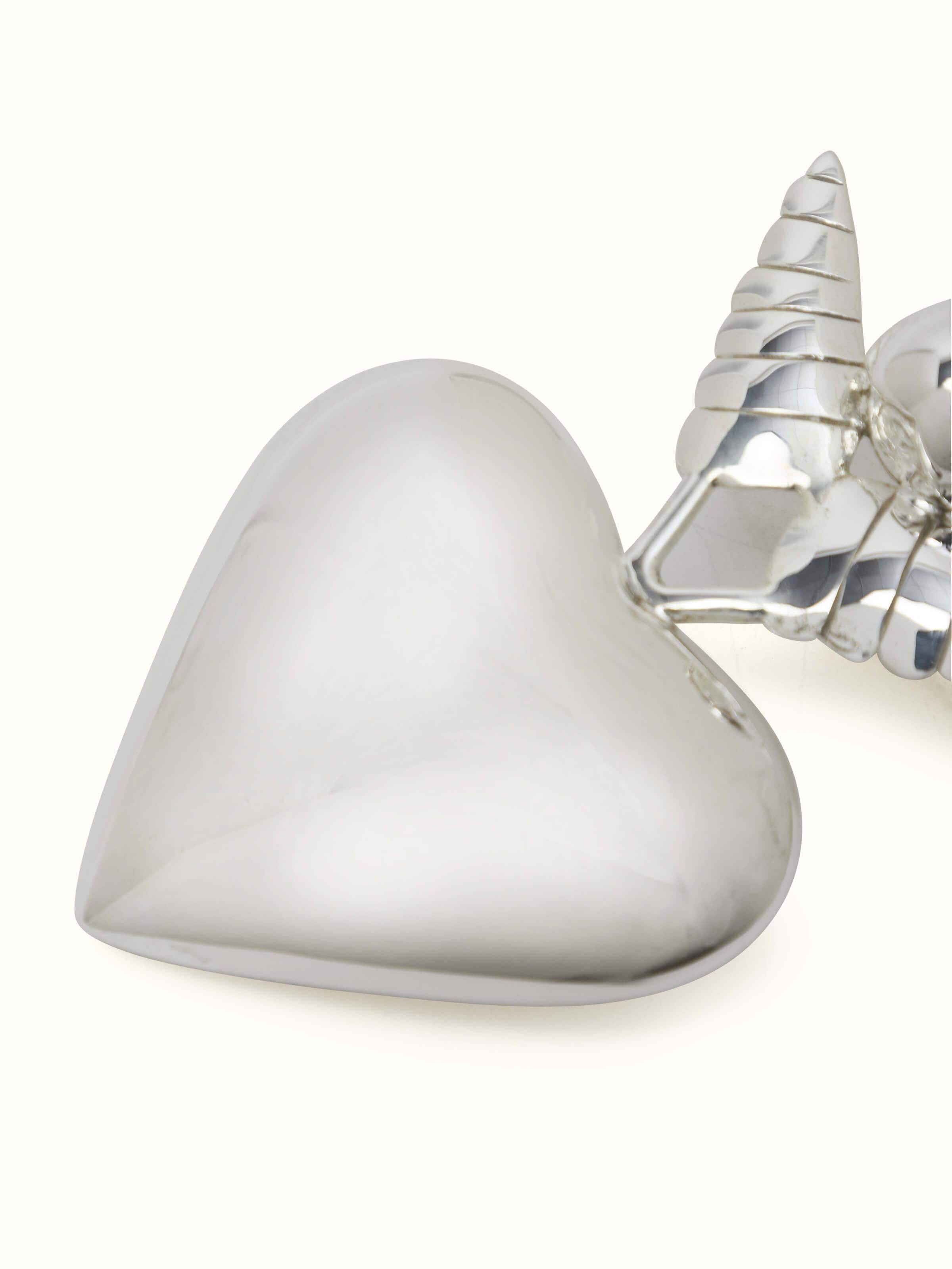 Detail view of Silver Angel Rattle Toy focusing on its intricate design and silver detailing.