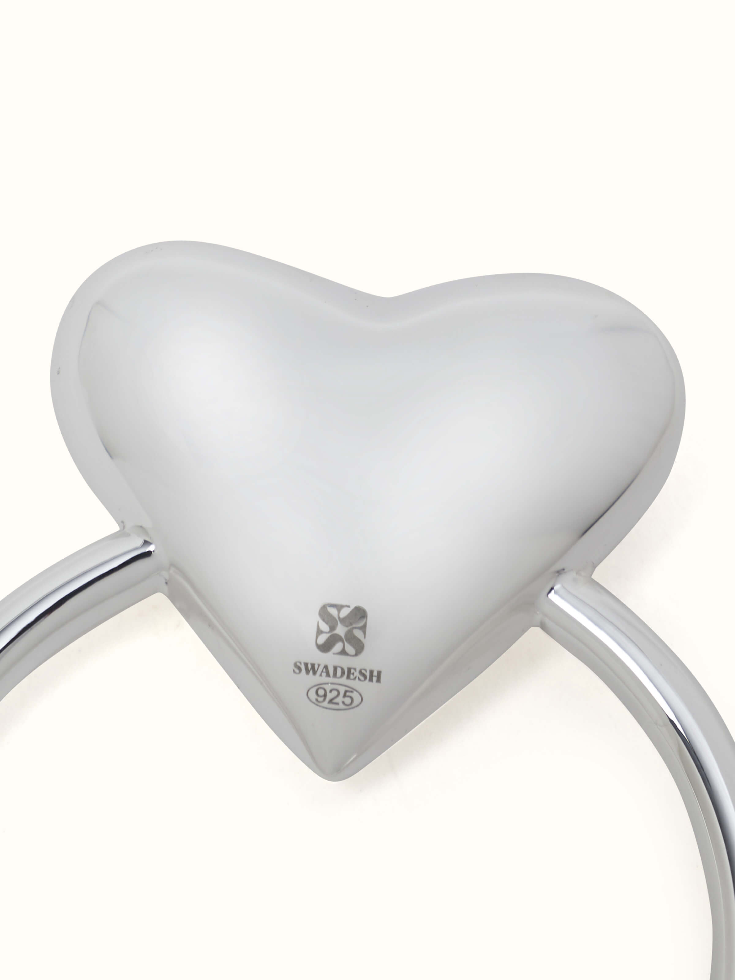 Detail view of Silver Heart Rattle Toy highlighting the texture and craftsmanship of the rattle.