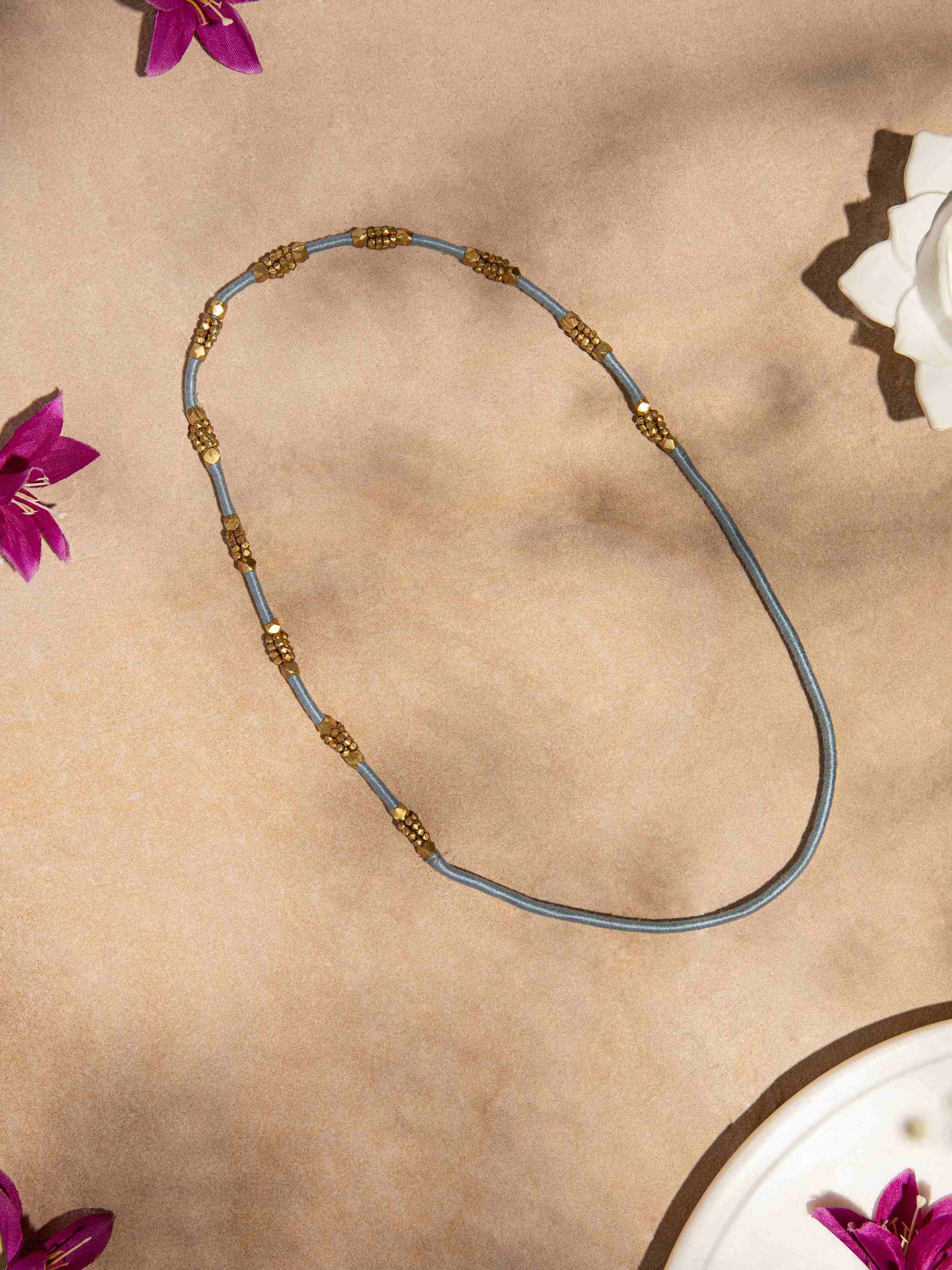 Side view of Dhokra Long Necklace emphasizing its length and traditional craftsmanship.