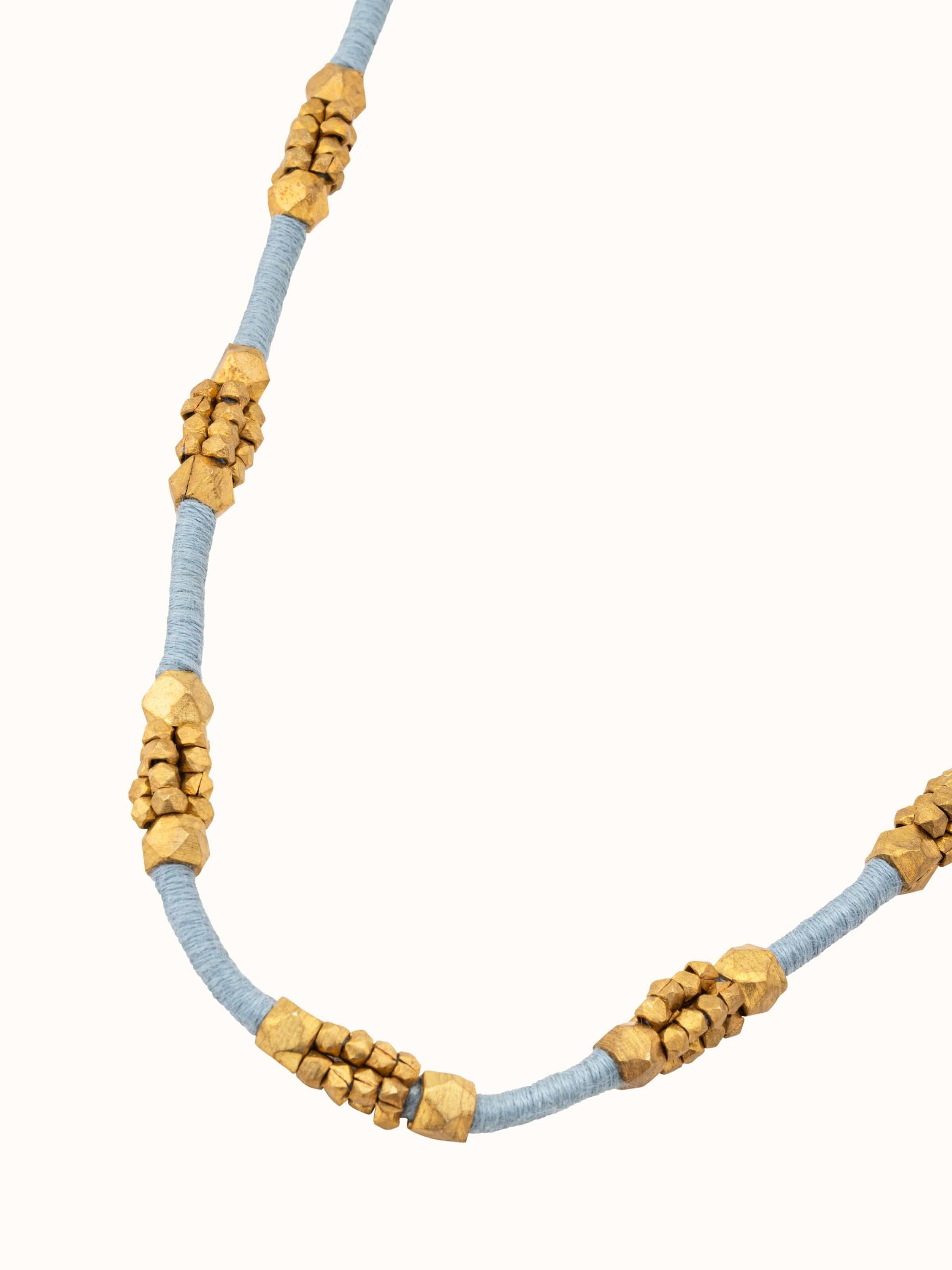 Angled view of Dhokra Long Necklace showcasing intricate metalwork and design.