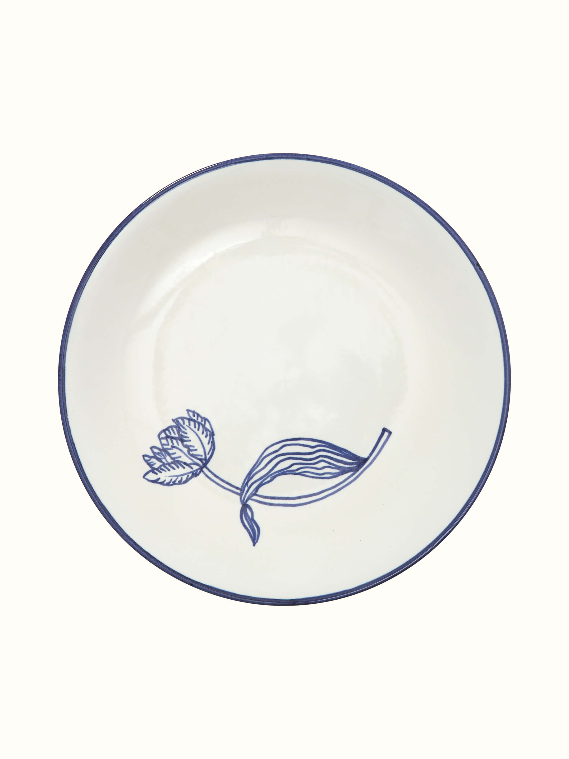 Side view of white and blue Khurja pottery ceramic dinner plates, emphasizing their detailed design and smooth glaze.