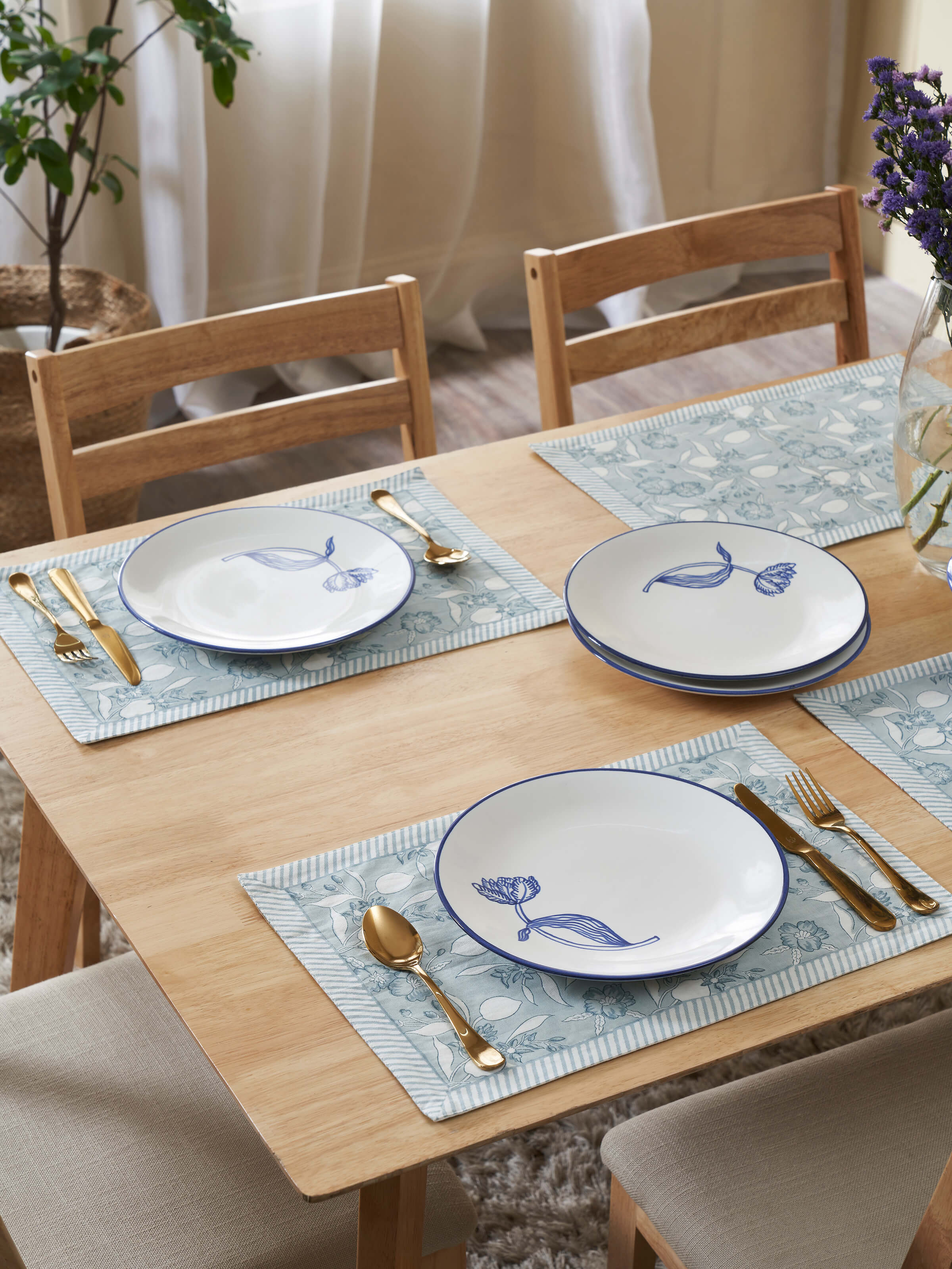 Front view of white and blue Khurja pottery ceramic dinner plates, highlighting the elegant patterns and finish.