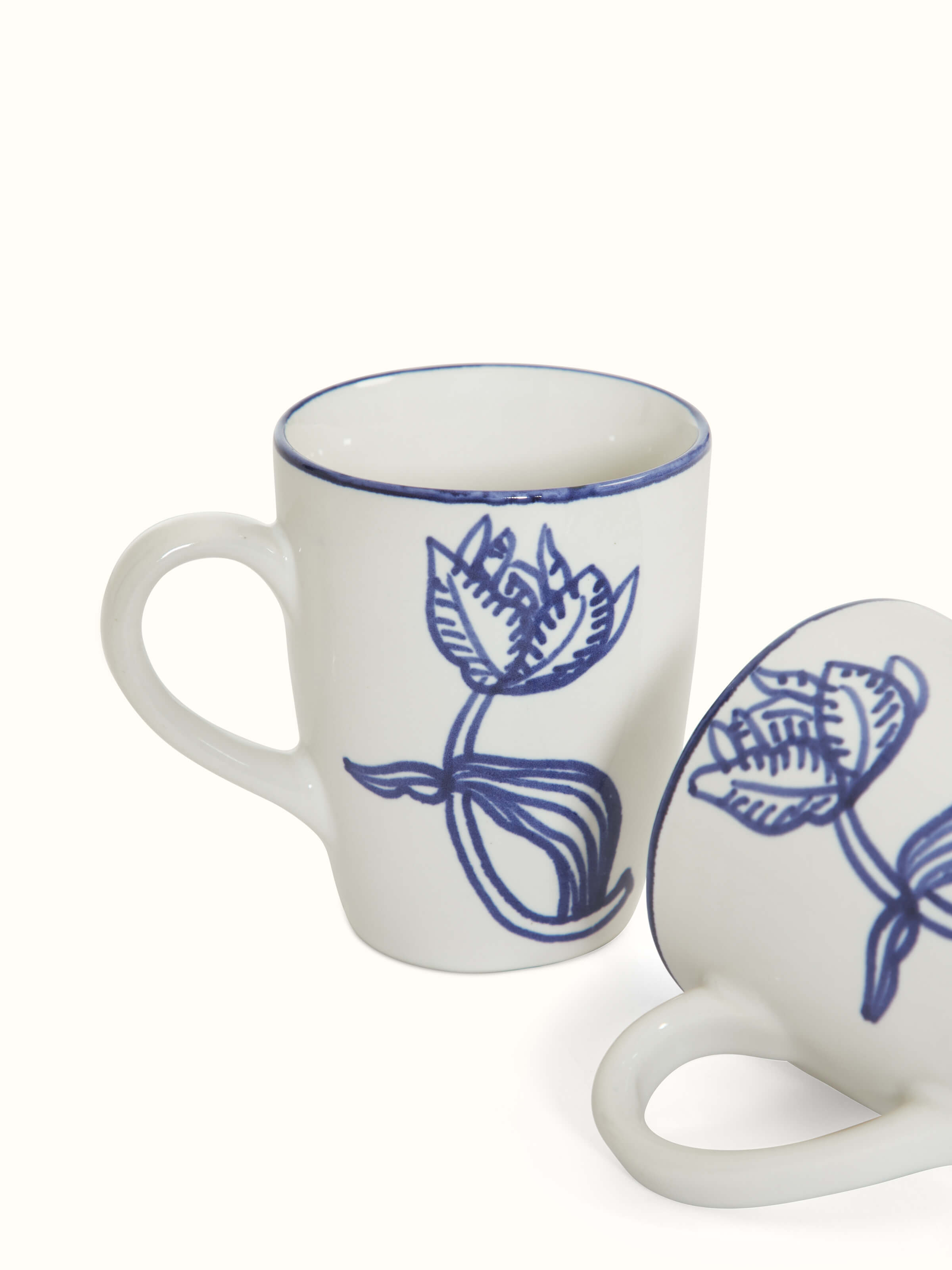 Angled view of Khurja pottery ceramic coffee mugs white & blue (2 pcs) showcasing elegant handles