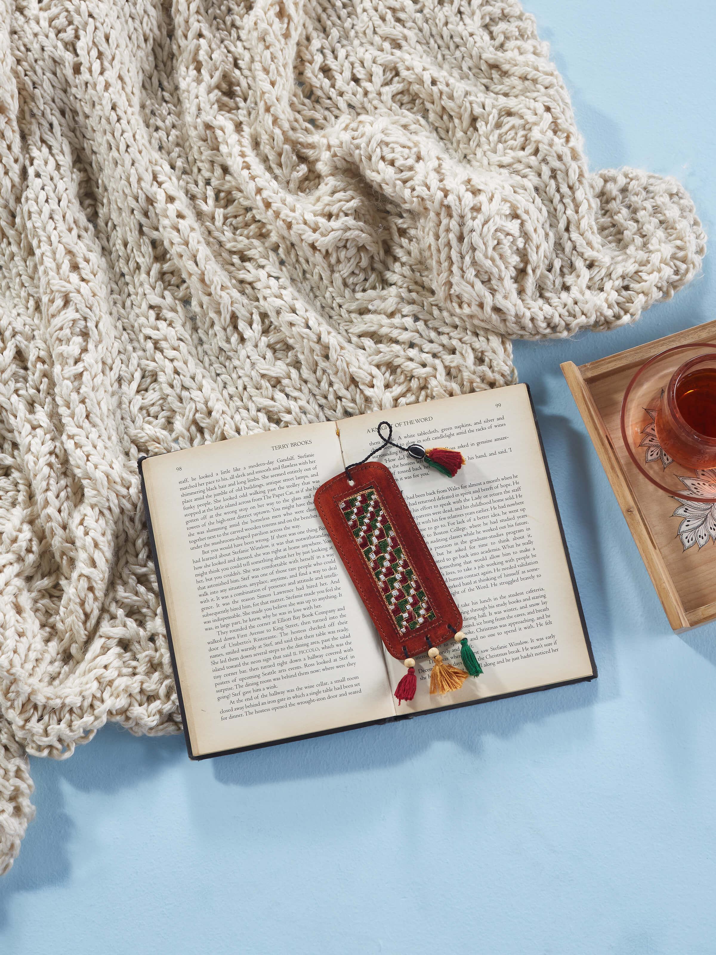 Side view of Kutch embroidery leather bookmark in red, highlighting the leather texture.