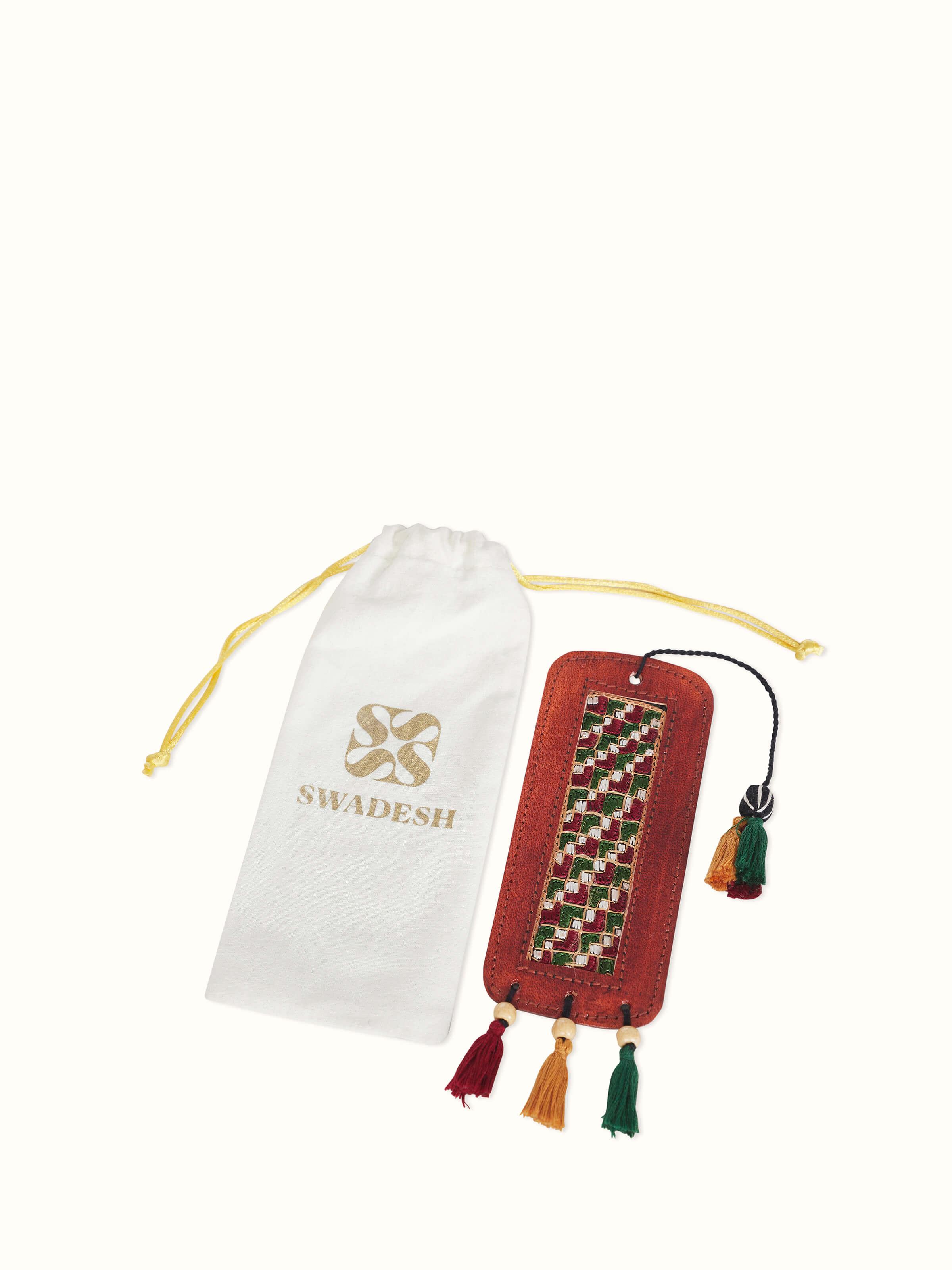Close-up view of Kutch embroidery leather bookmark in red, focusing on the detailed stitching.