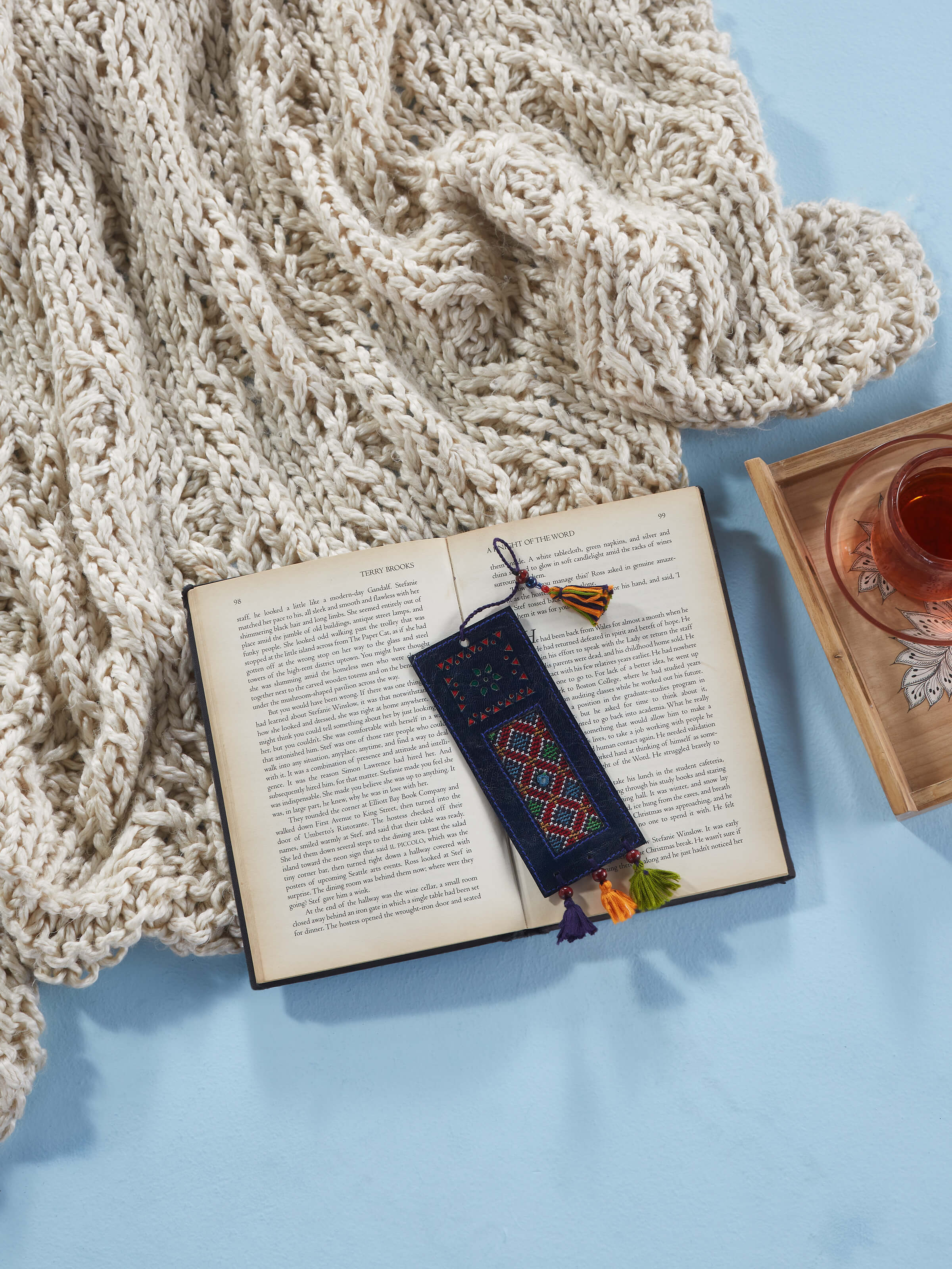 Close-up of Kutch embroidery leather bookmark in blue, highlighting the detailed embroidery work.