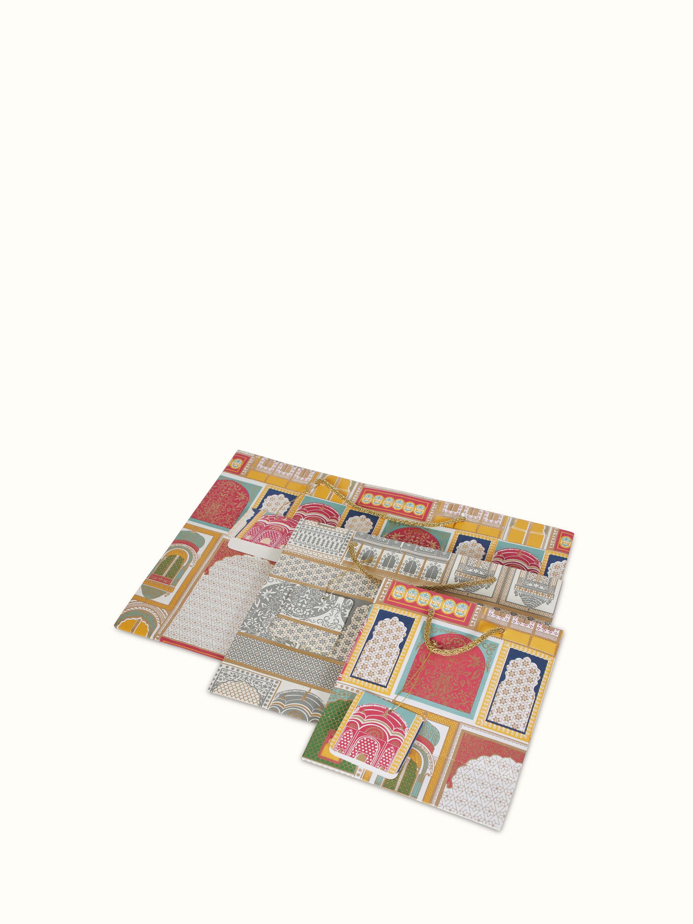 Angled view of Handmade paper gift bags white (3 pcs) showing their elegant form.