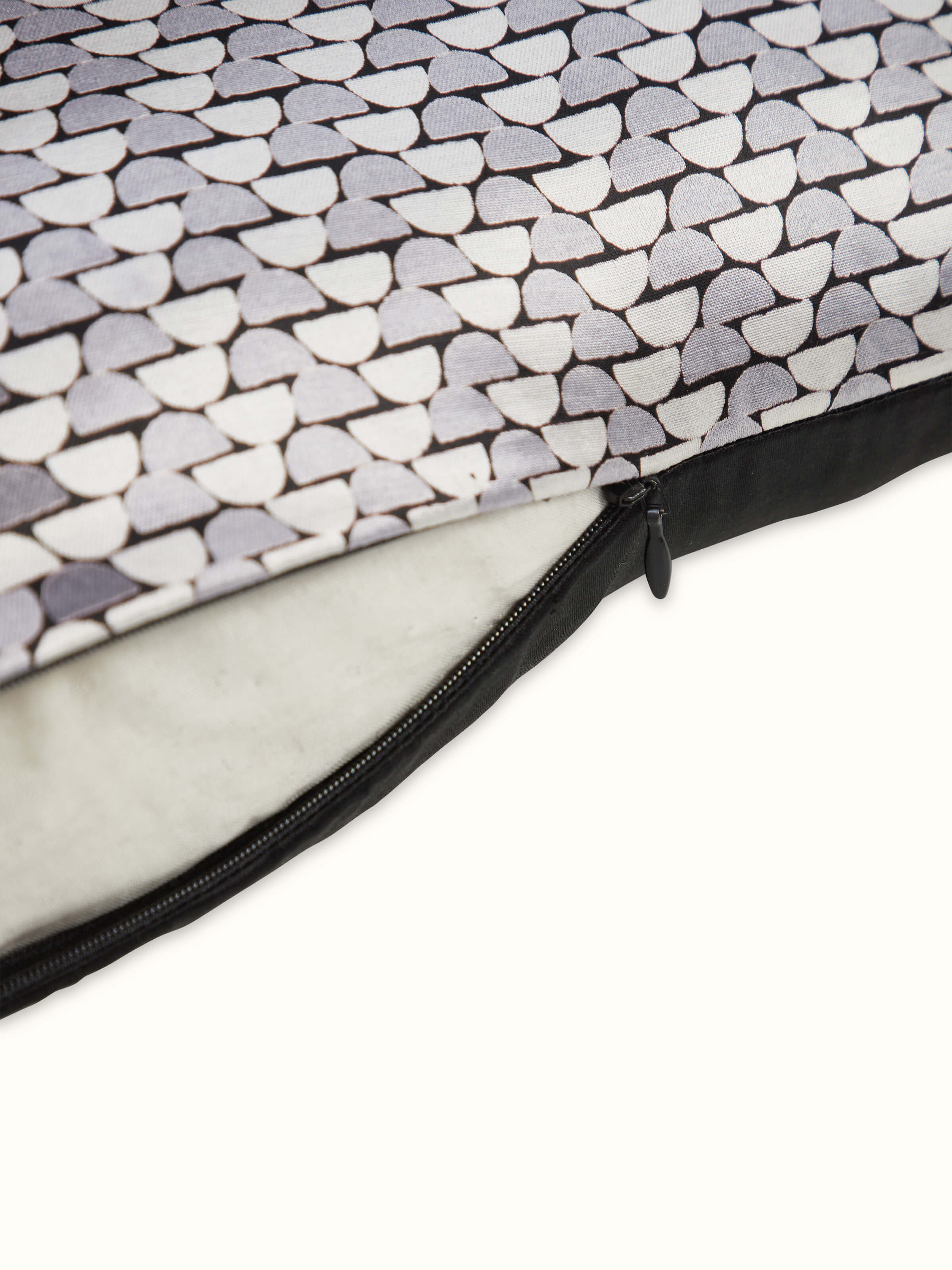 Angled view of Sanganeri print design in geometric motifs on grey cushion cover.