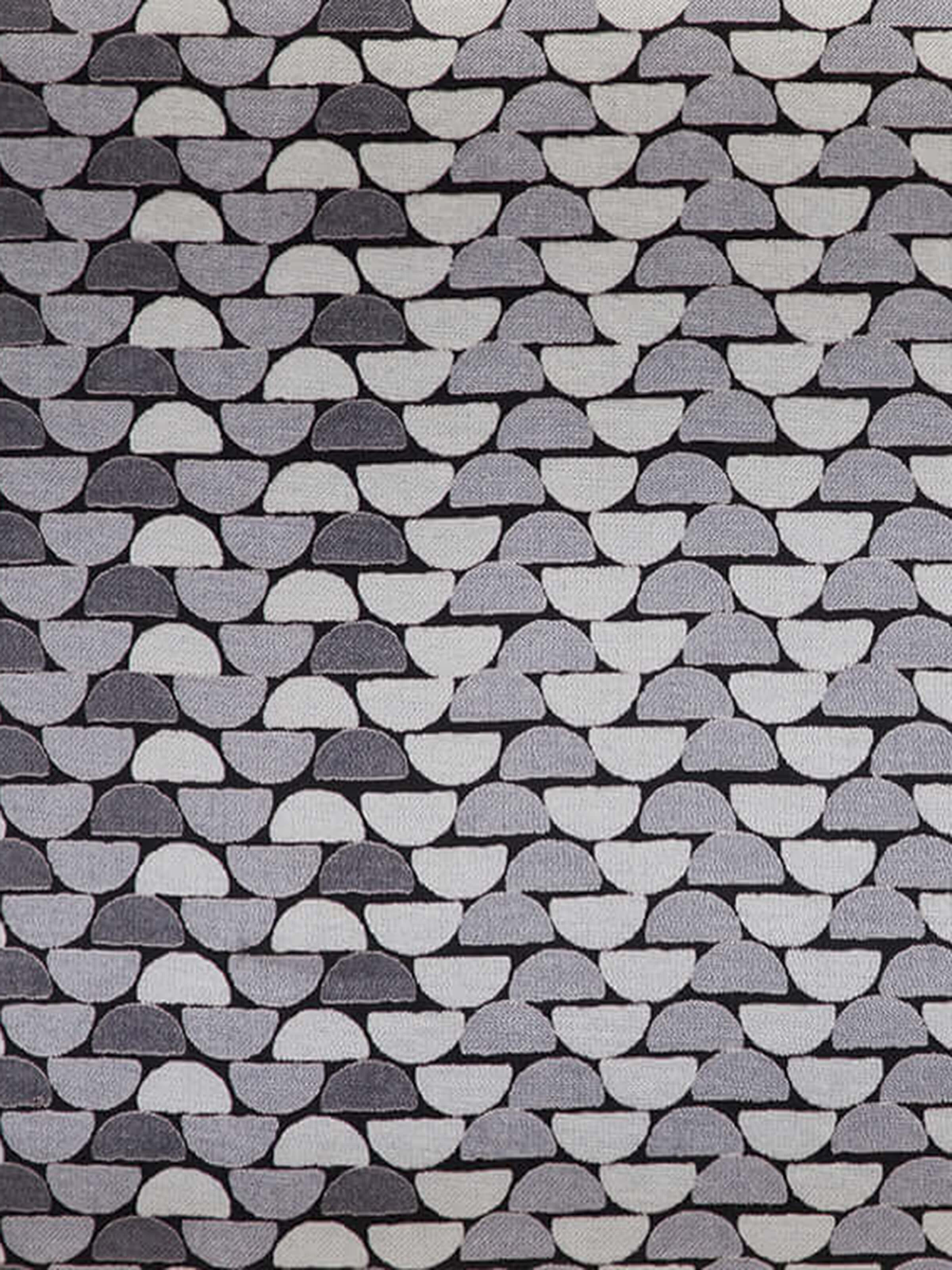 Detail shot of block print detailing with fine lines on soft cotton blend fabric.