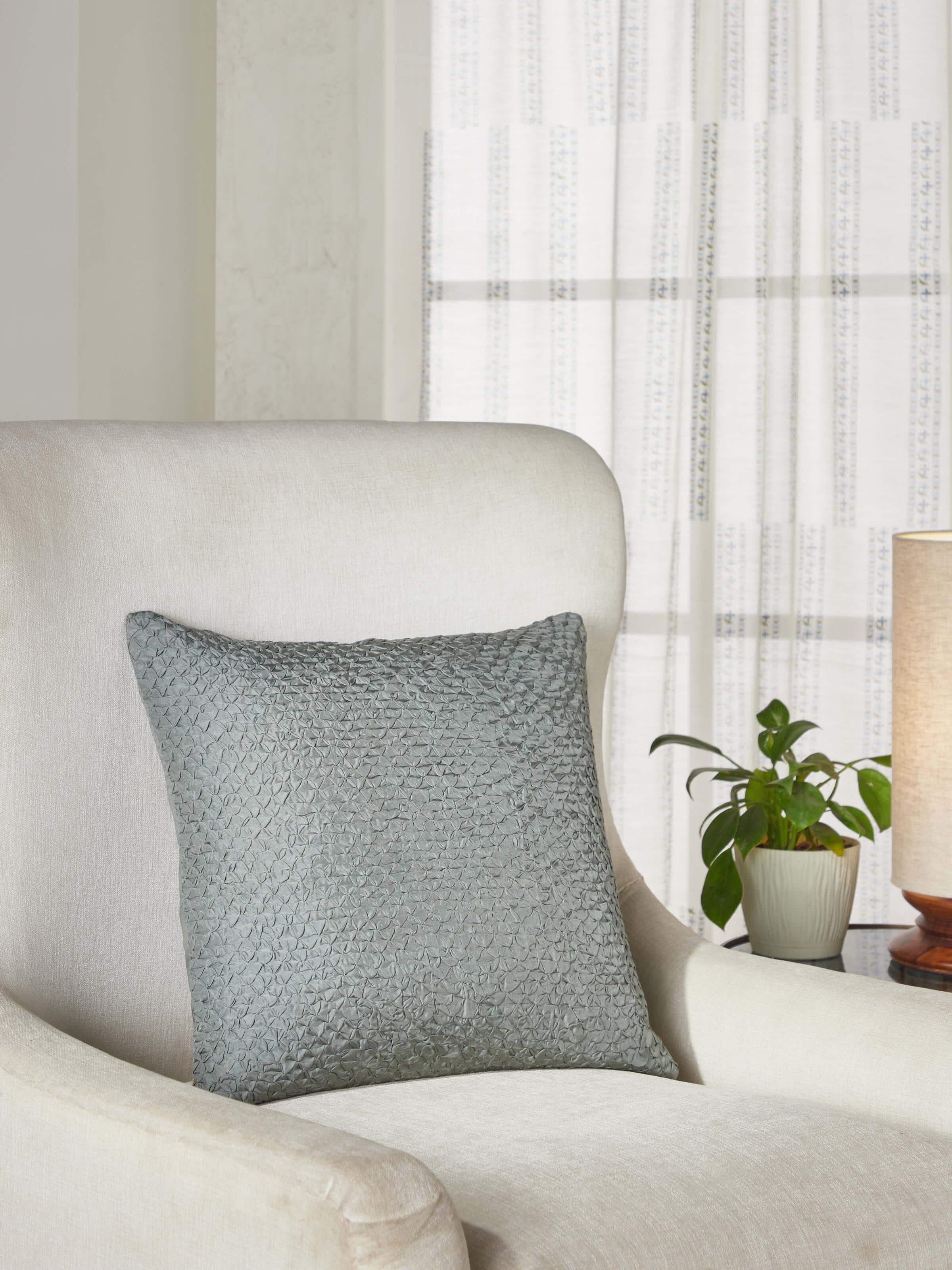 Close-up of Svarupa Grey Textured Silk Bandhani Tie and Dye Cushion Cover highlighting the detailed dye patterns.