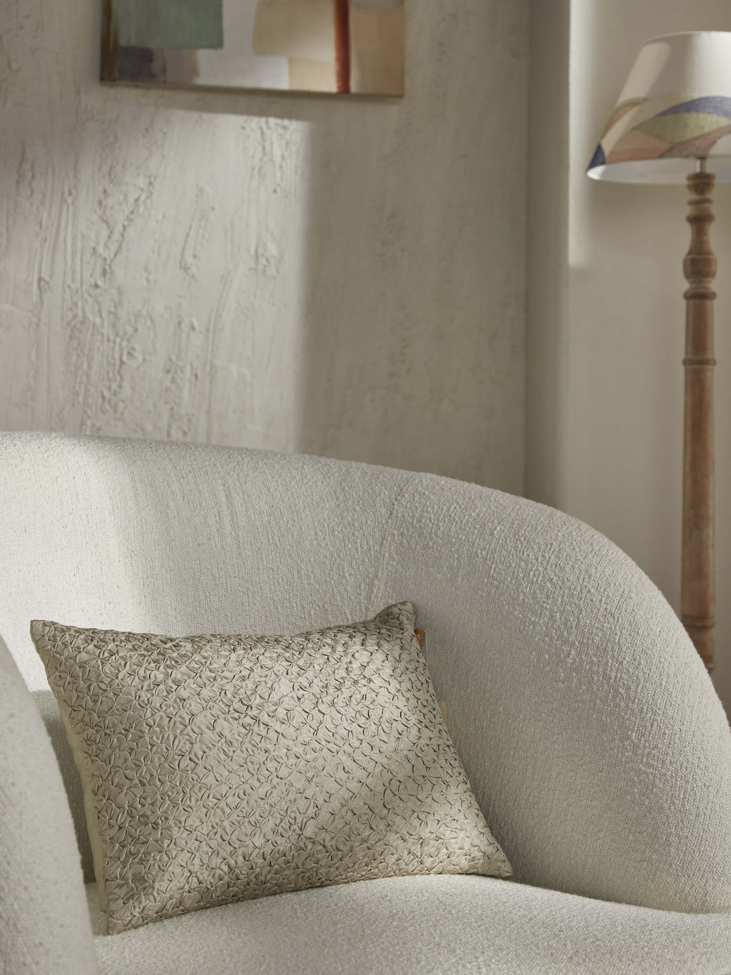 Lifestyle shot of beige Bandhani cushion styled with muted-toned decor for a subtle ethnic touch.
