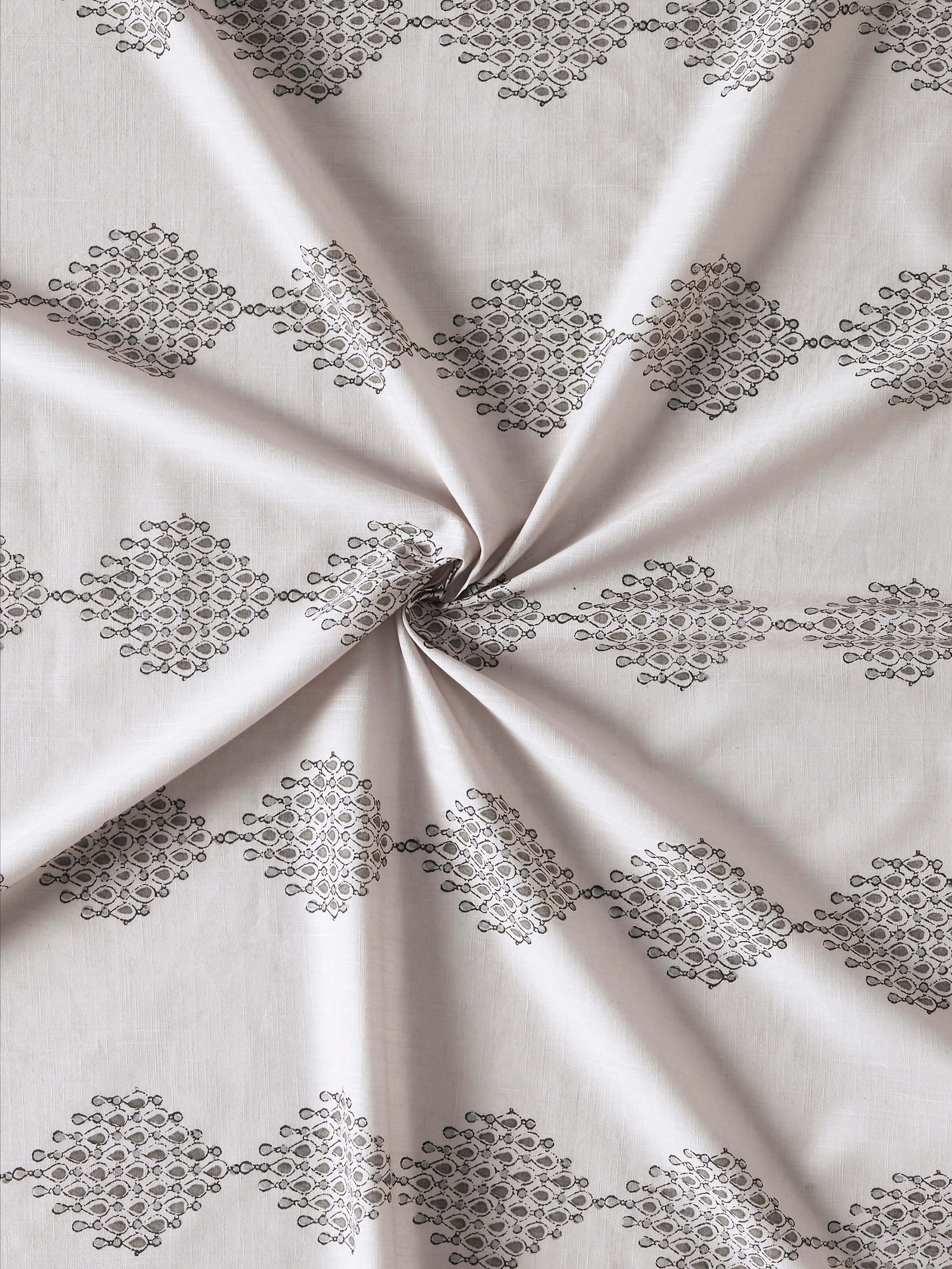 Angled view of Rambagh Light Grey Modern Geo Diamond Cotton Sanganeri Block Printed Curtain (9 ft) emphasizing the drape and texture of the cotton fabric