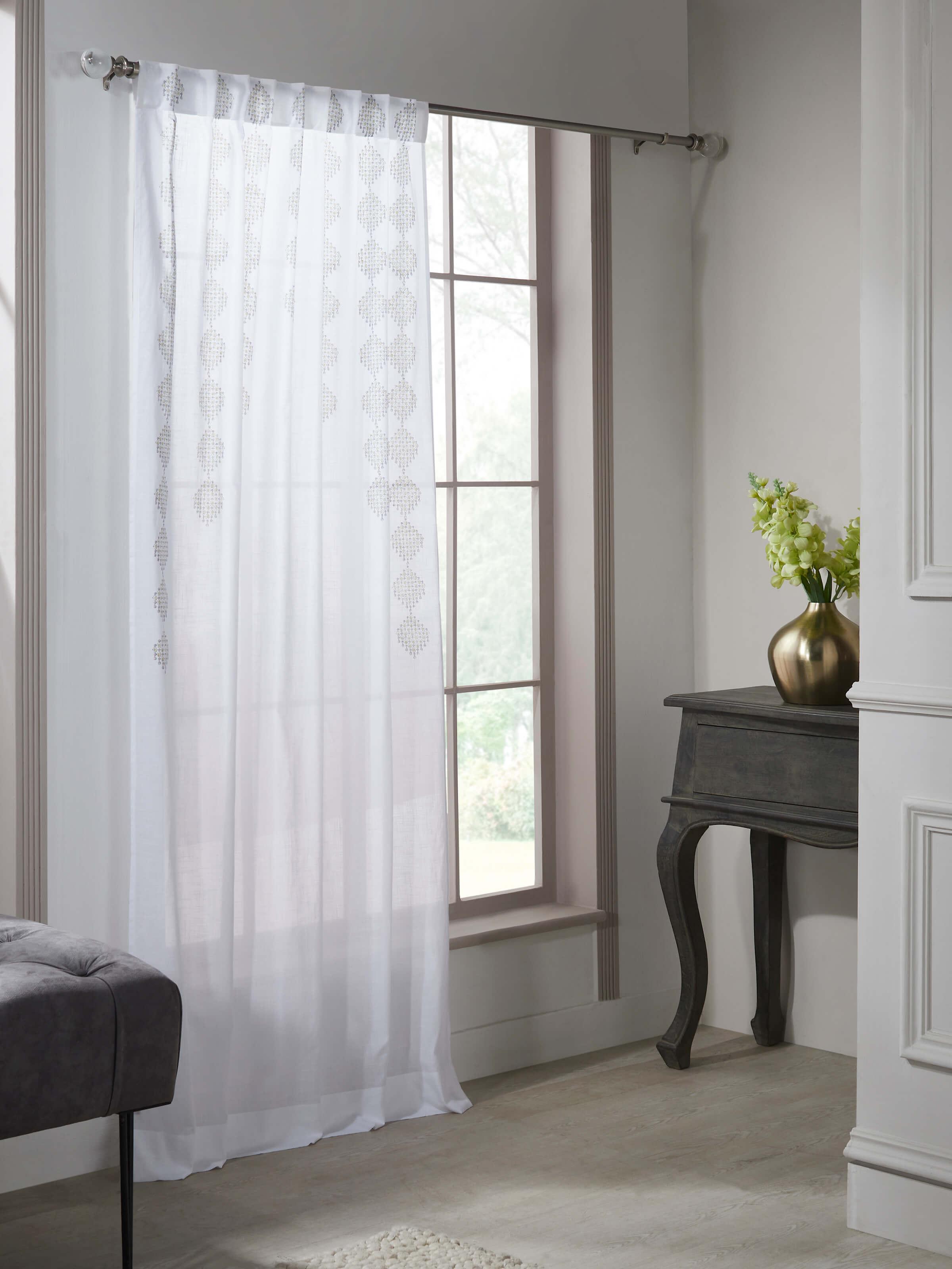 Angled view of Rambagh white modern geo diamond cotton Sanganeri block printed curtain (7 ft) highlighting design