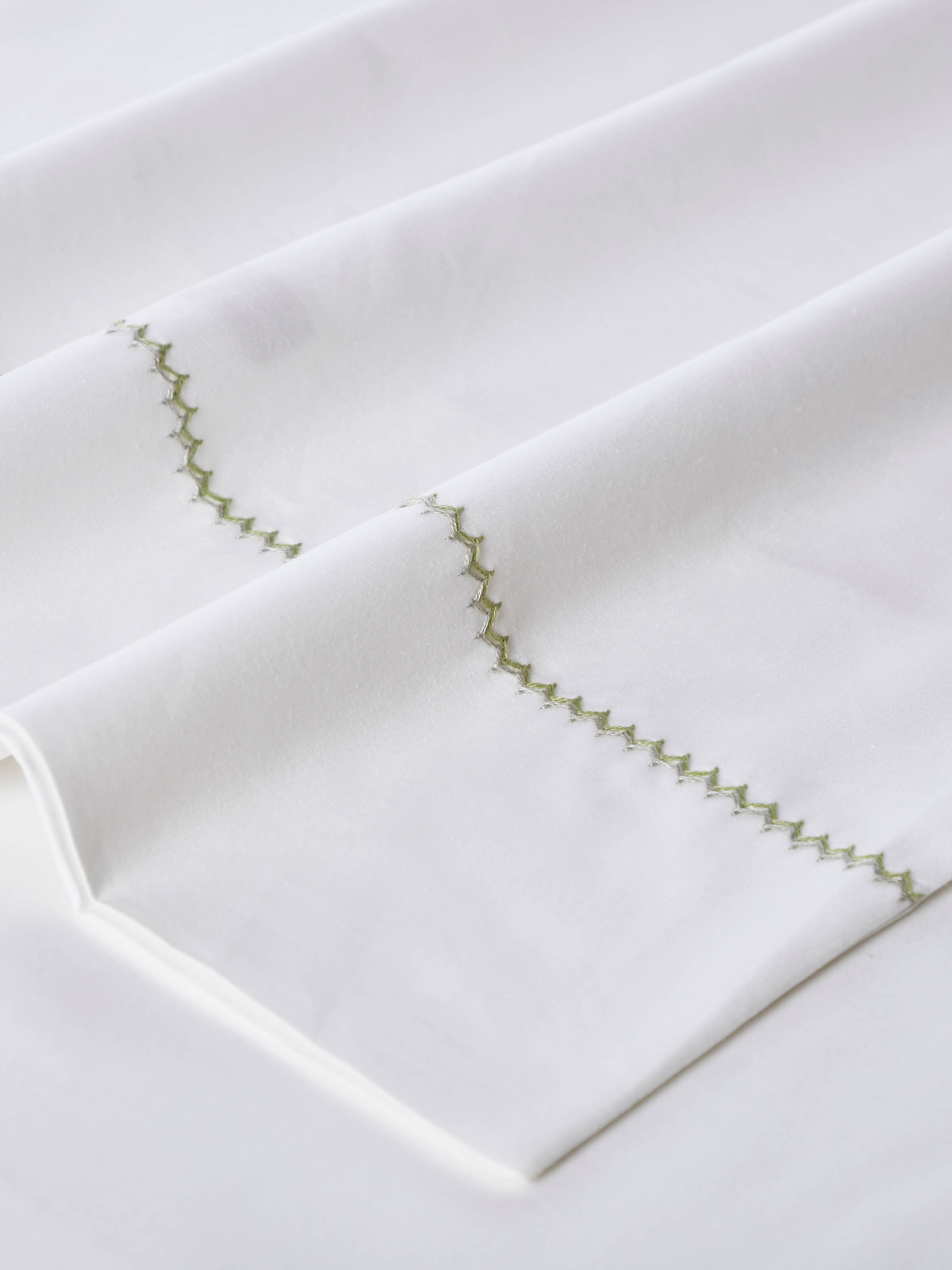 Detailed shot of Rambagh green stripe cotton hand embroidered bedsheet king set (3 pcs) showcasing intricate patterns