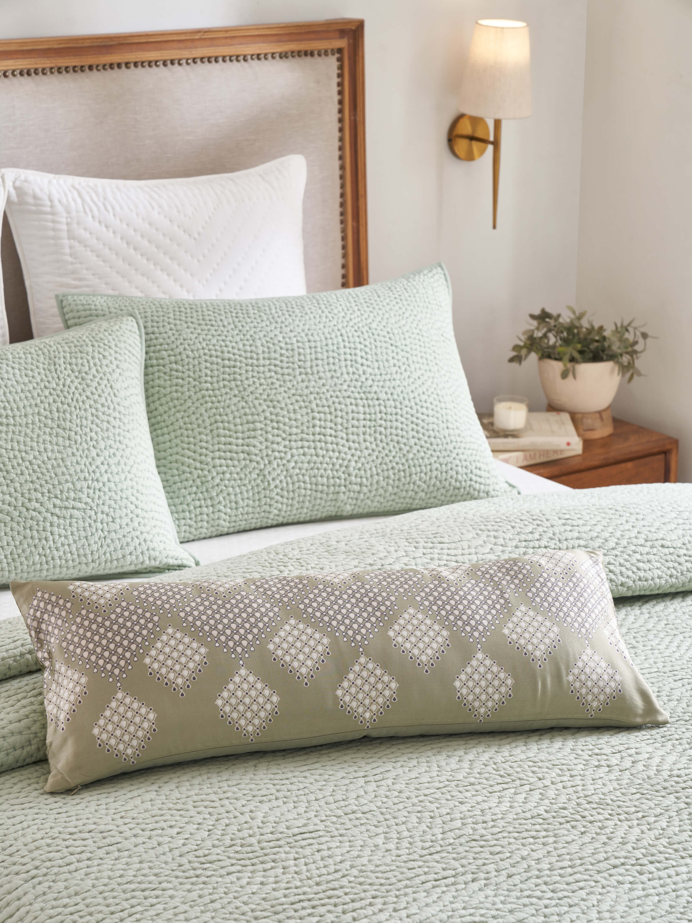 Side view of Rambagh green modern geo viscose cotton Sanganeri block printed cushion cover showcasing the geometric print and fabric texture.