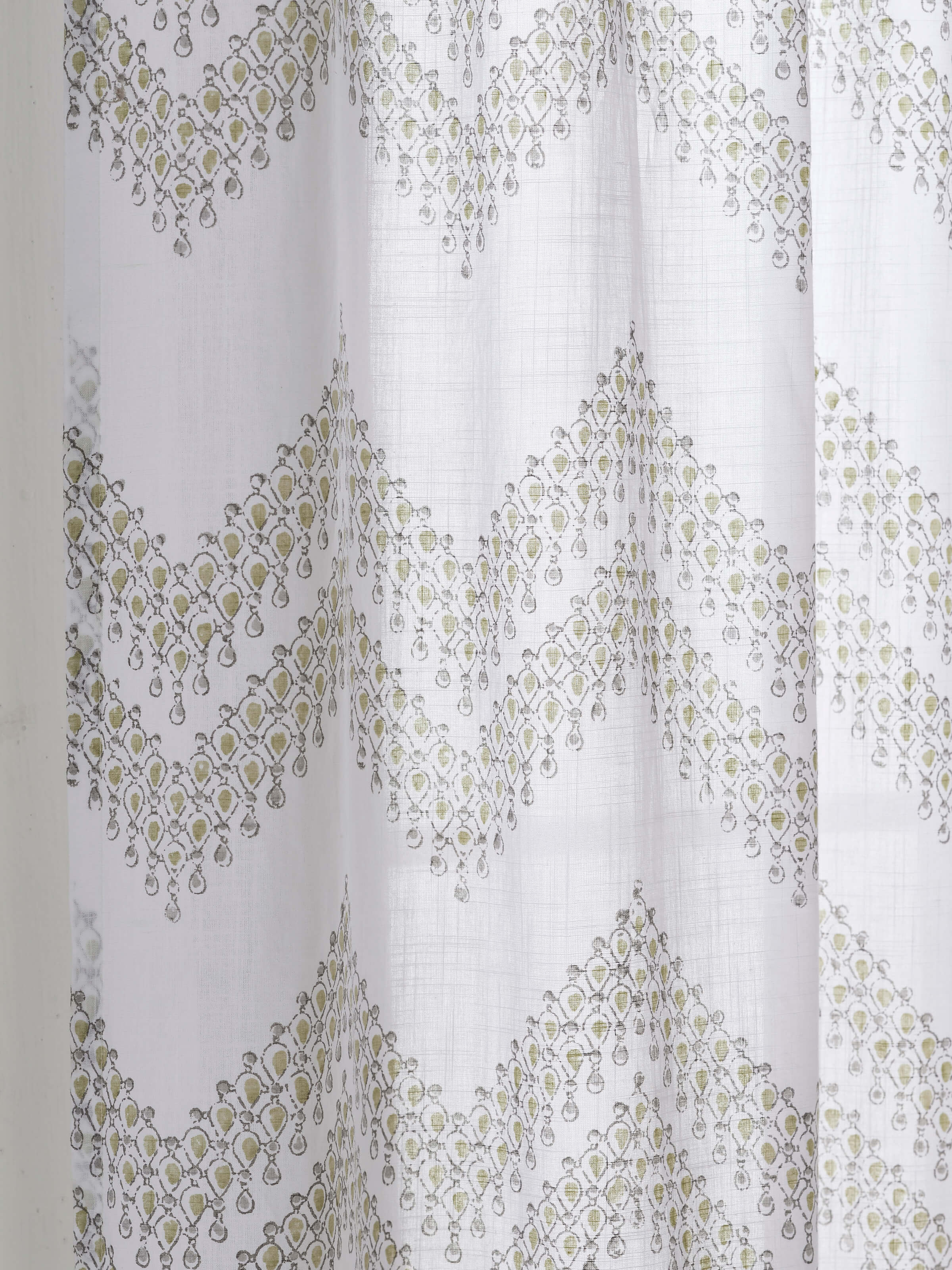 Angled view of Rambagh White Modern Geo Cotton Sanganeri Block Printed Curtain (9 ft), showcasing the curtain’s geometric pattern.