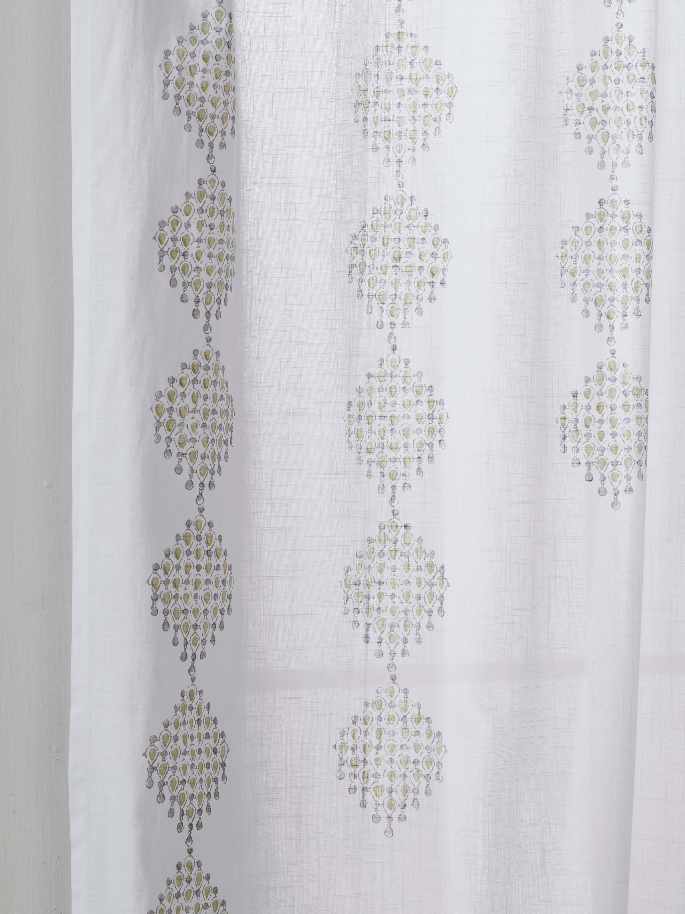 Detailed view of the geometric block print on the Rambagh white and green cotton curtain